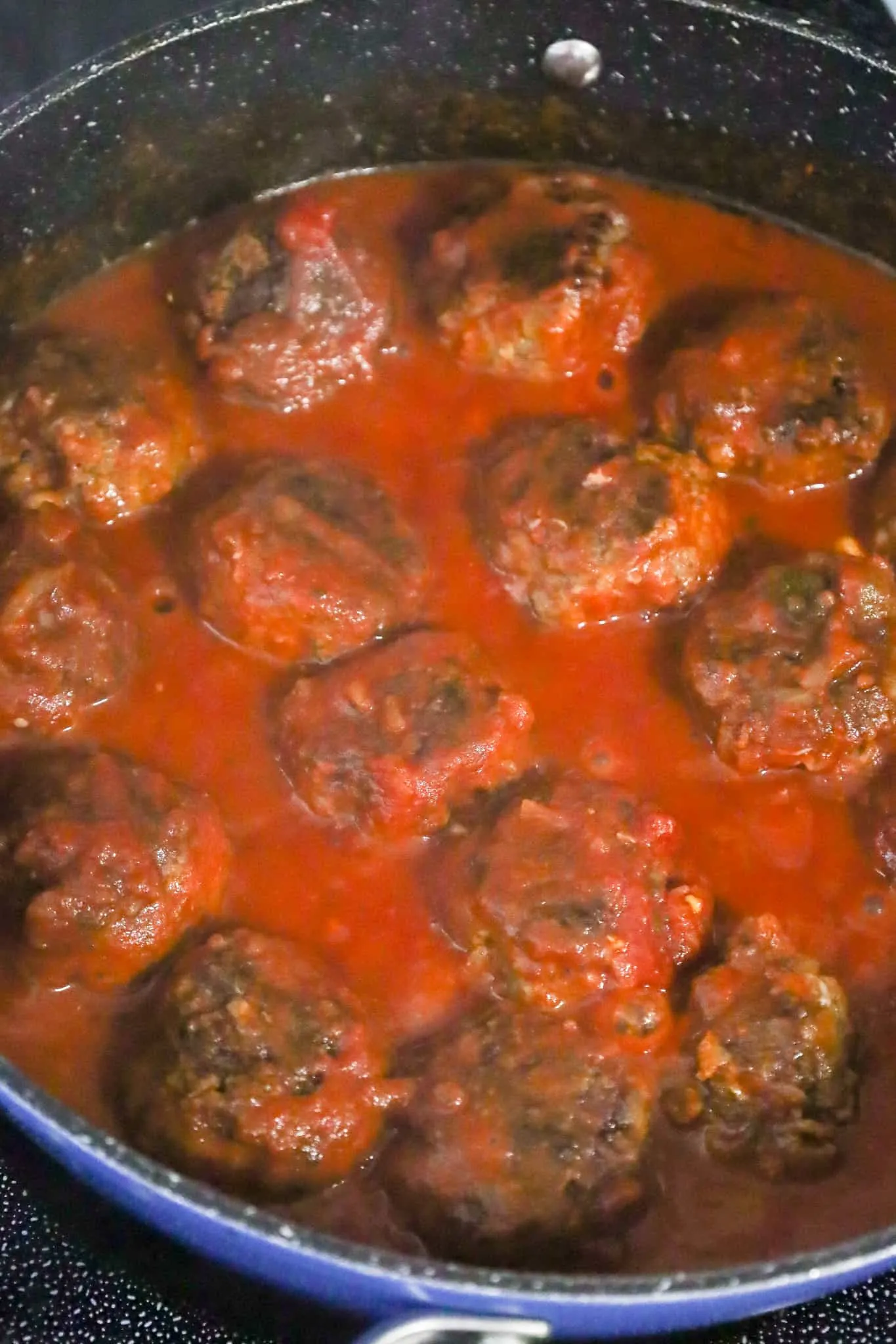 meatballs cooking in tomato sauce and salsa mixture