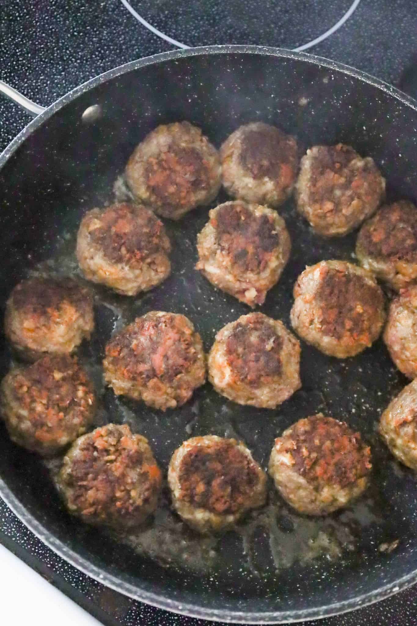 meatballs cooking in a skillet