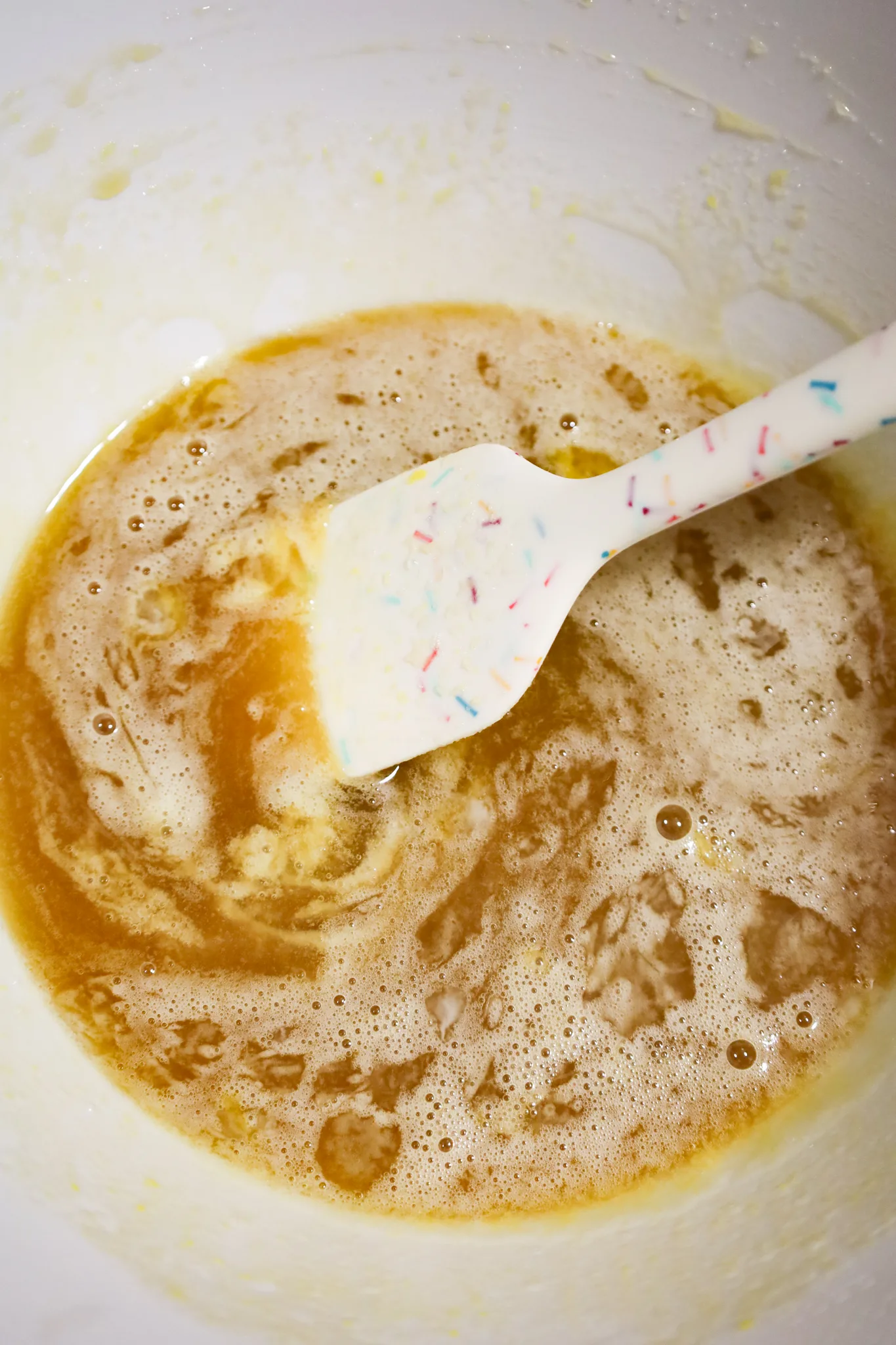 melted butter, vanilla, corn syrup and brown sugar mixture in a mixing bowl
