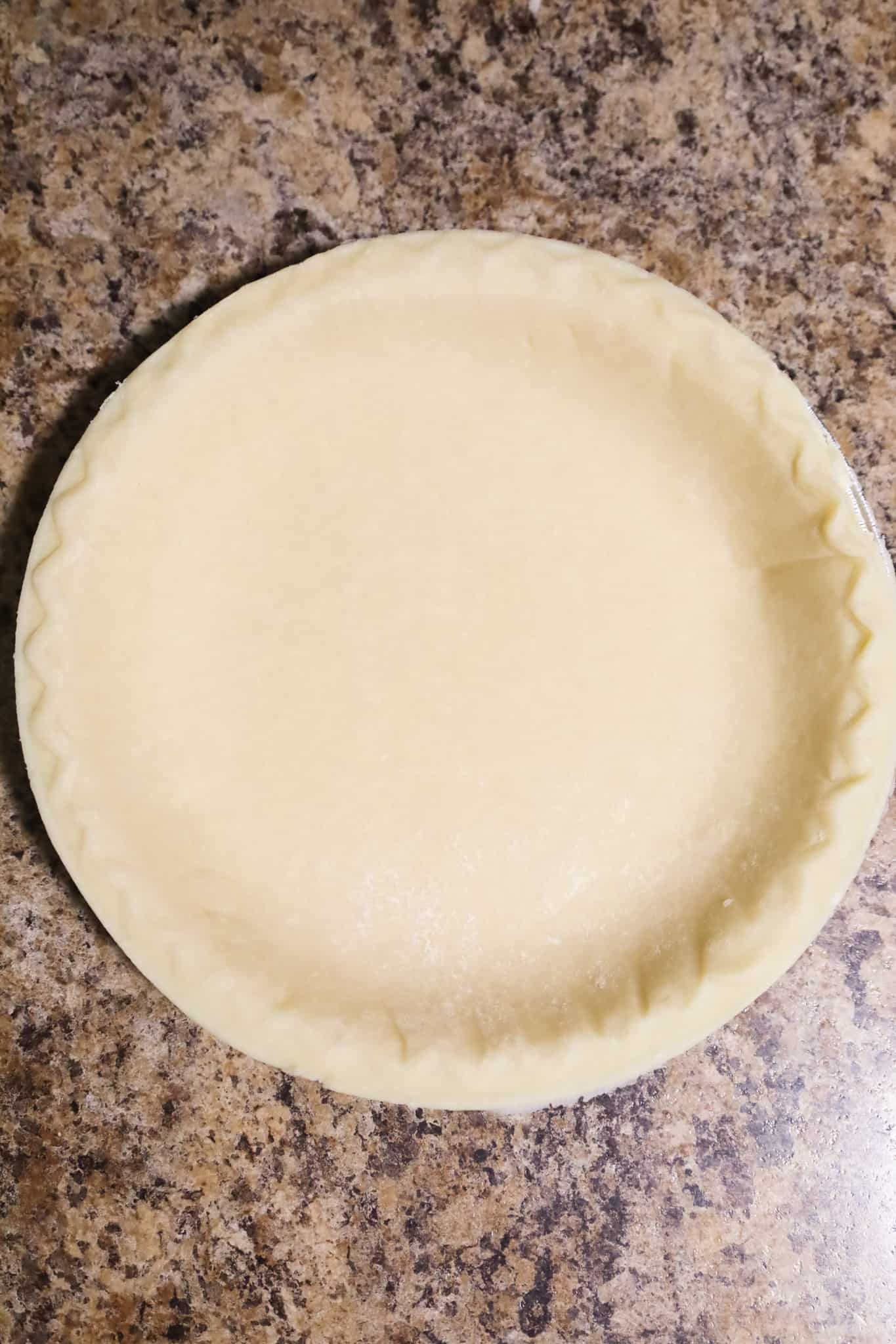 raw pie crust in a pie plate