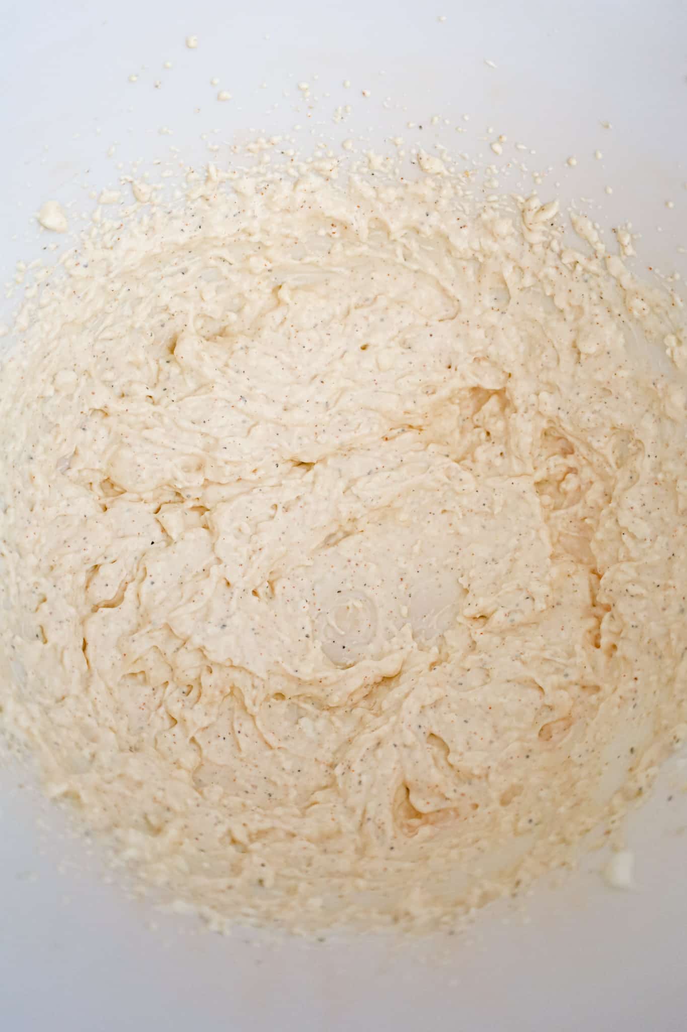 cream cheese, sour cream and spice mixture in a mixing bowl
