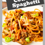 Cowboy Spaghetti is a robust pasta dish abundant with bacon, ground beef, Rotel diced tomatoes, green chilies, tomato sauce, BBQ sauce, shredded cheese, and finely chopped green onions.