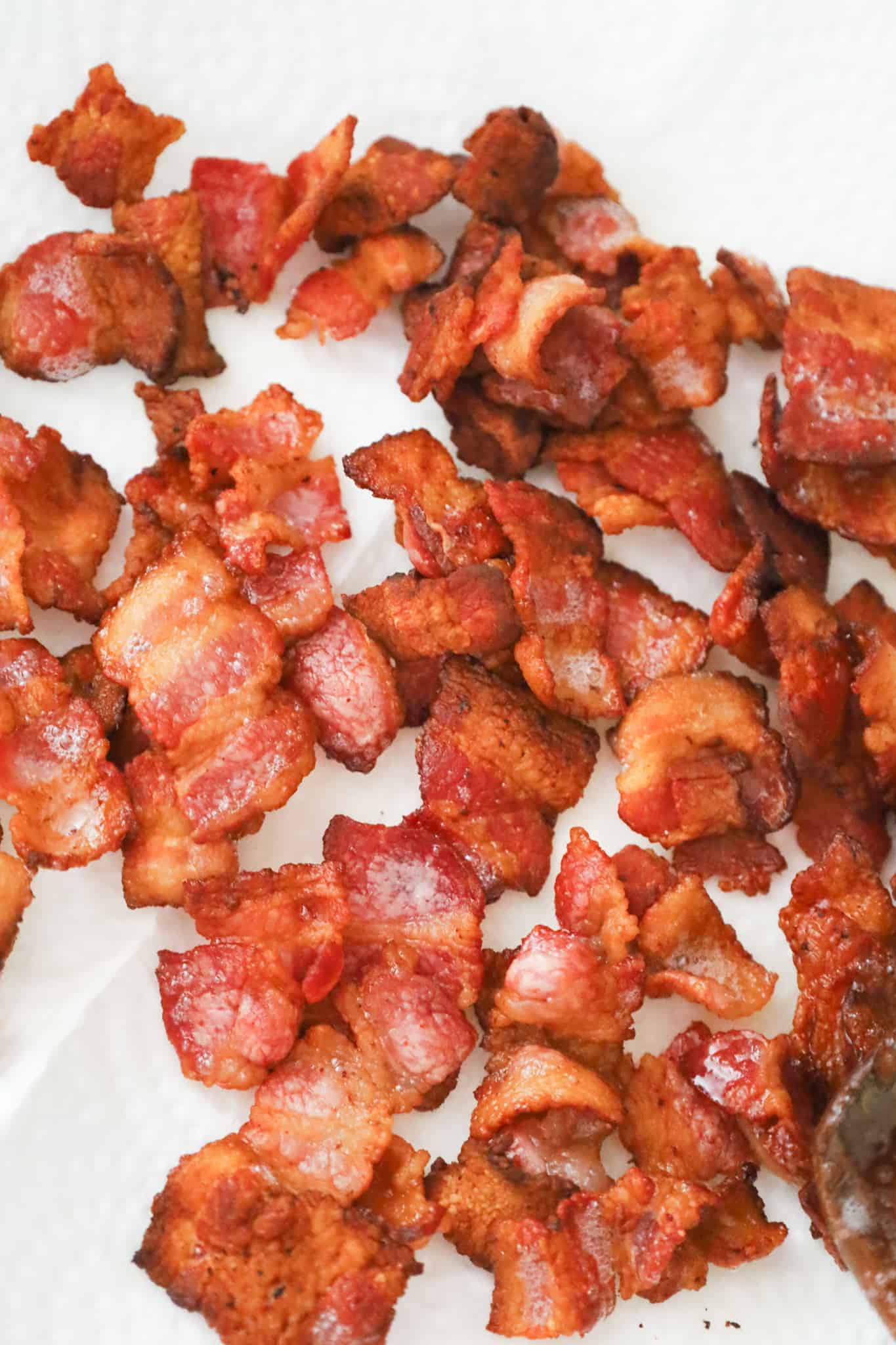cooked bacon pieces on paper towel