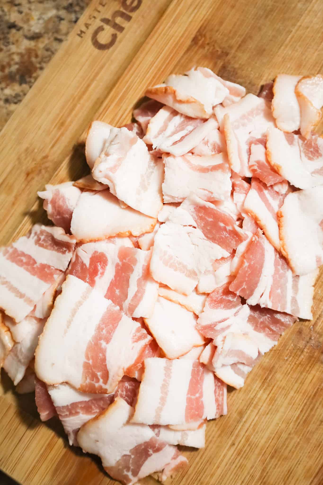 raw bacon pieces on a cutting board