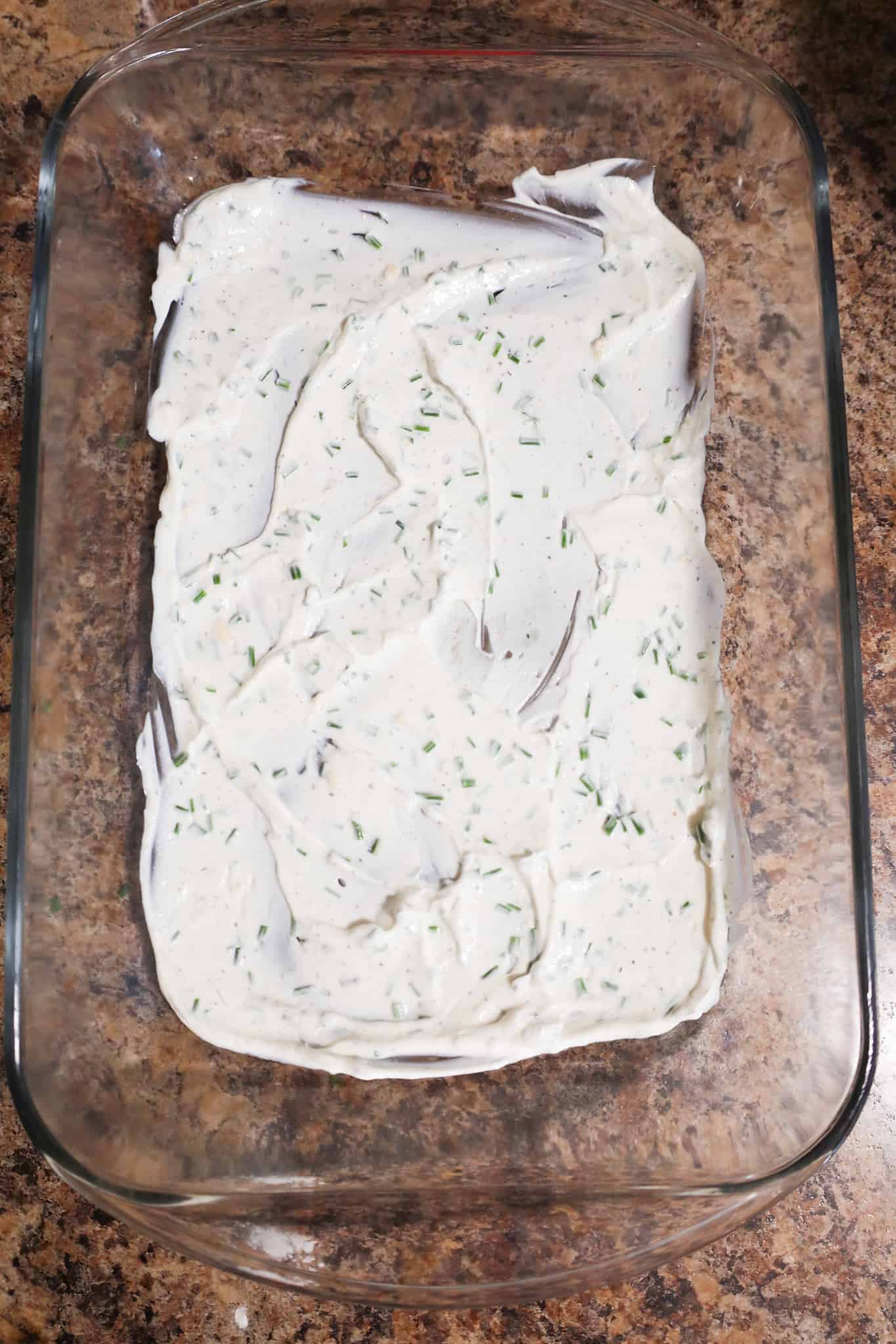 sour cream mixture spread in the bottom of a baking dish