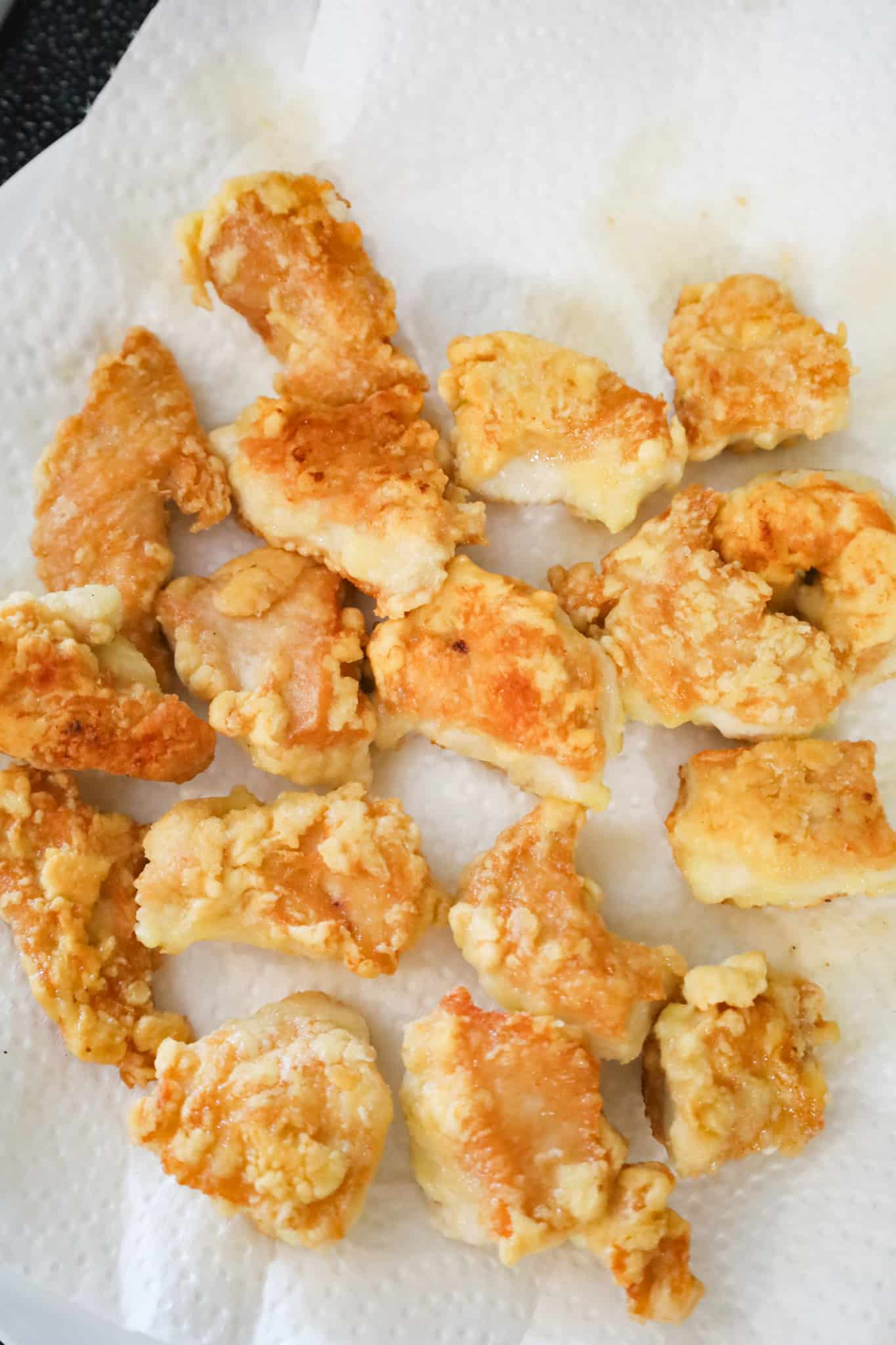 fried chicken chunks on a paper towel lined plate
