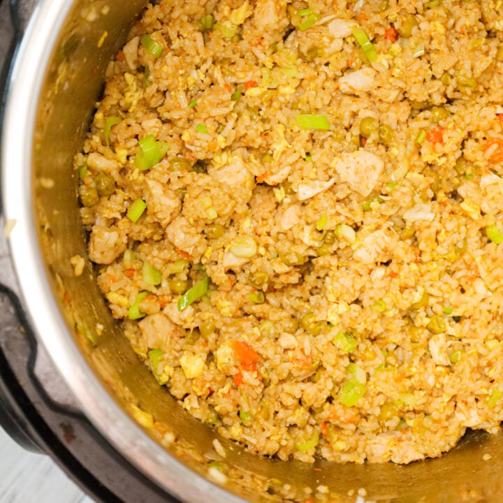 Instant Pot Chicken Fried Rice is an easy pressure cooker dinner recipe made with long grain white rice, boneless skinless chicken breasts, scrambled eggs and peas and carrots all seasoned with chicken broth, soy sauce and toasted sesame oil.