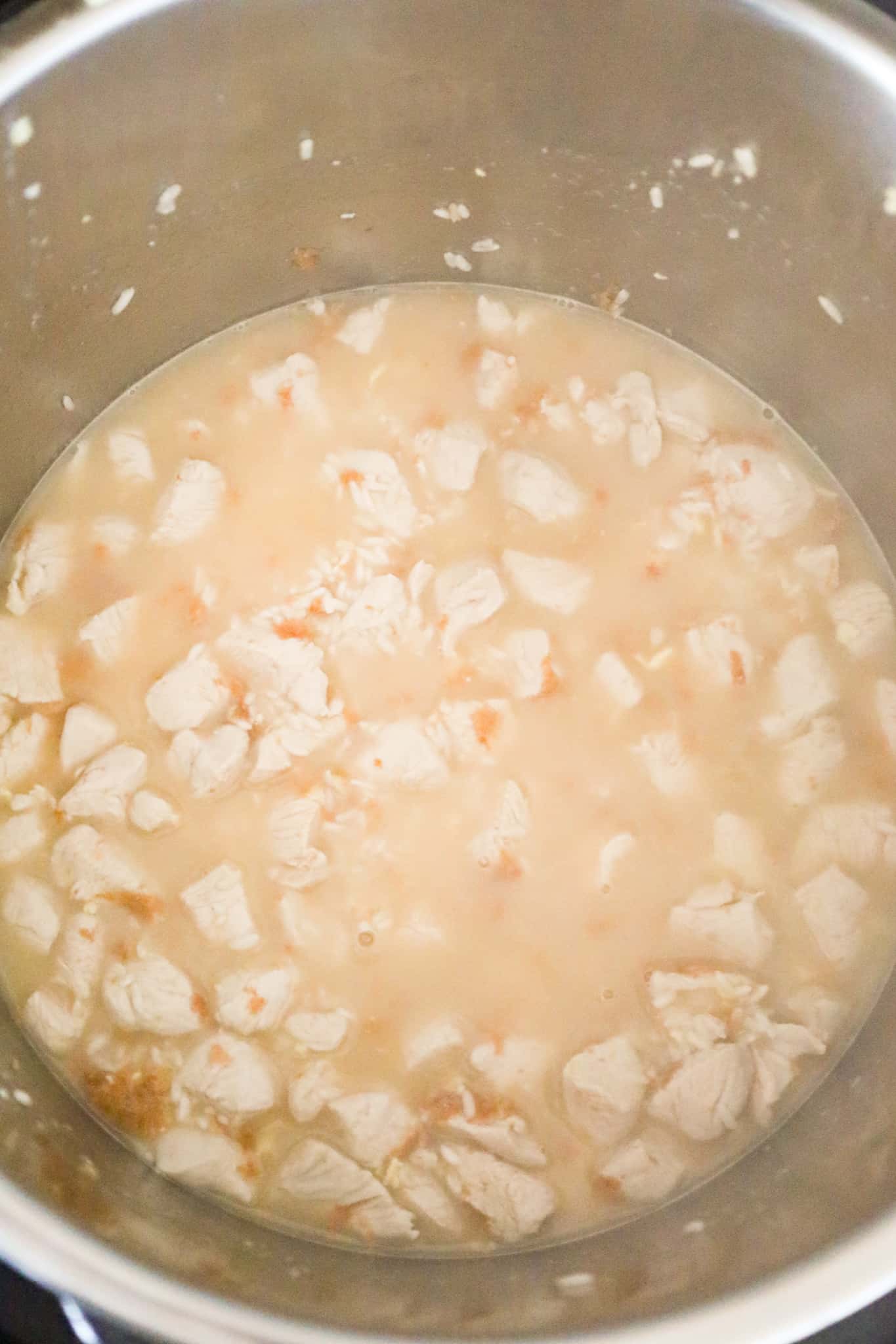 chicken broth added to pot with diced chicken and rice