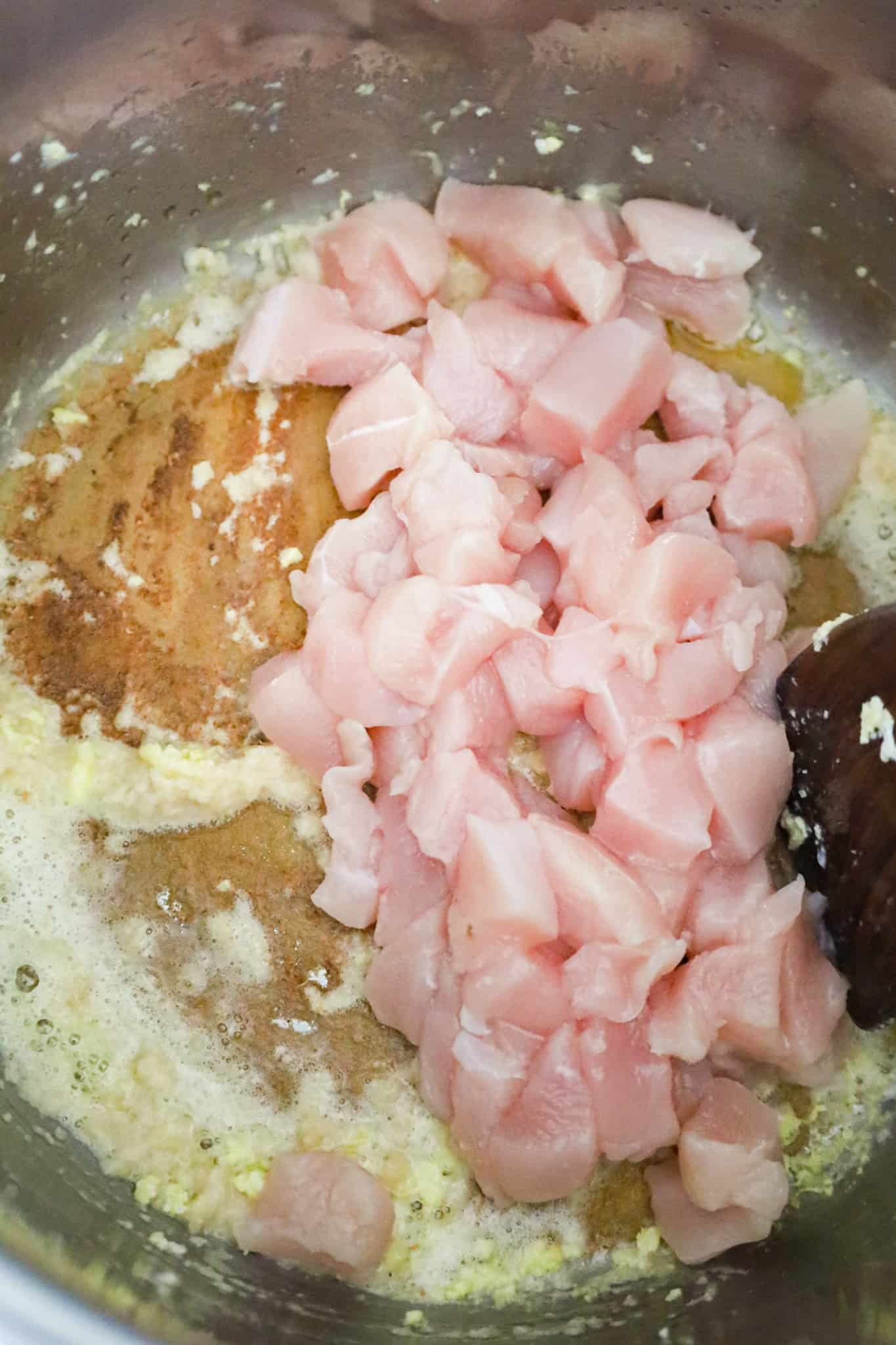 raw diced chicken breast cooking in an Instant Pot