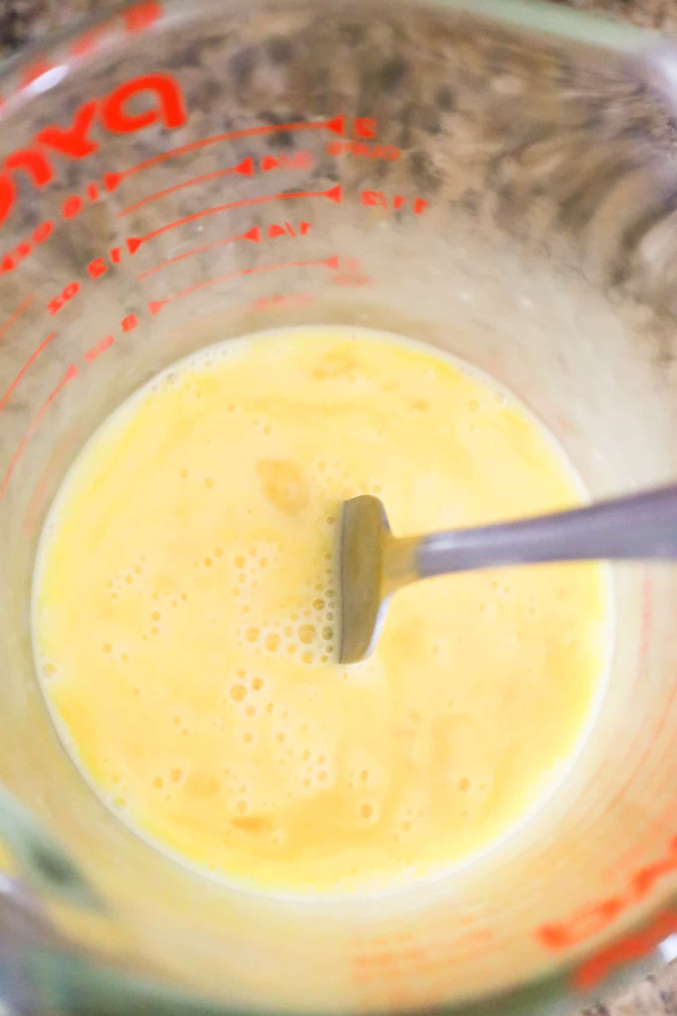 beaten eggs in a glass measuring cup