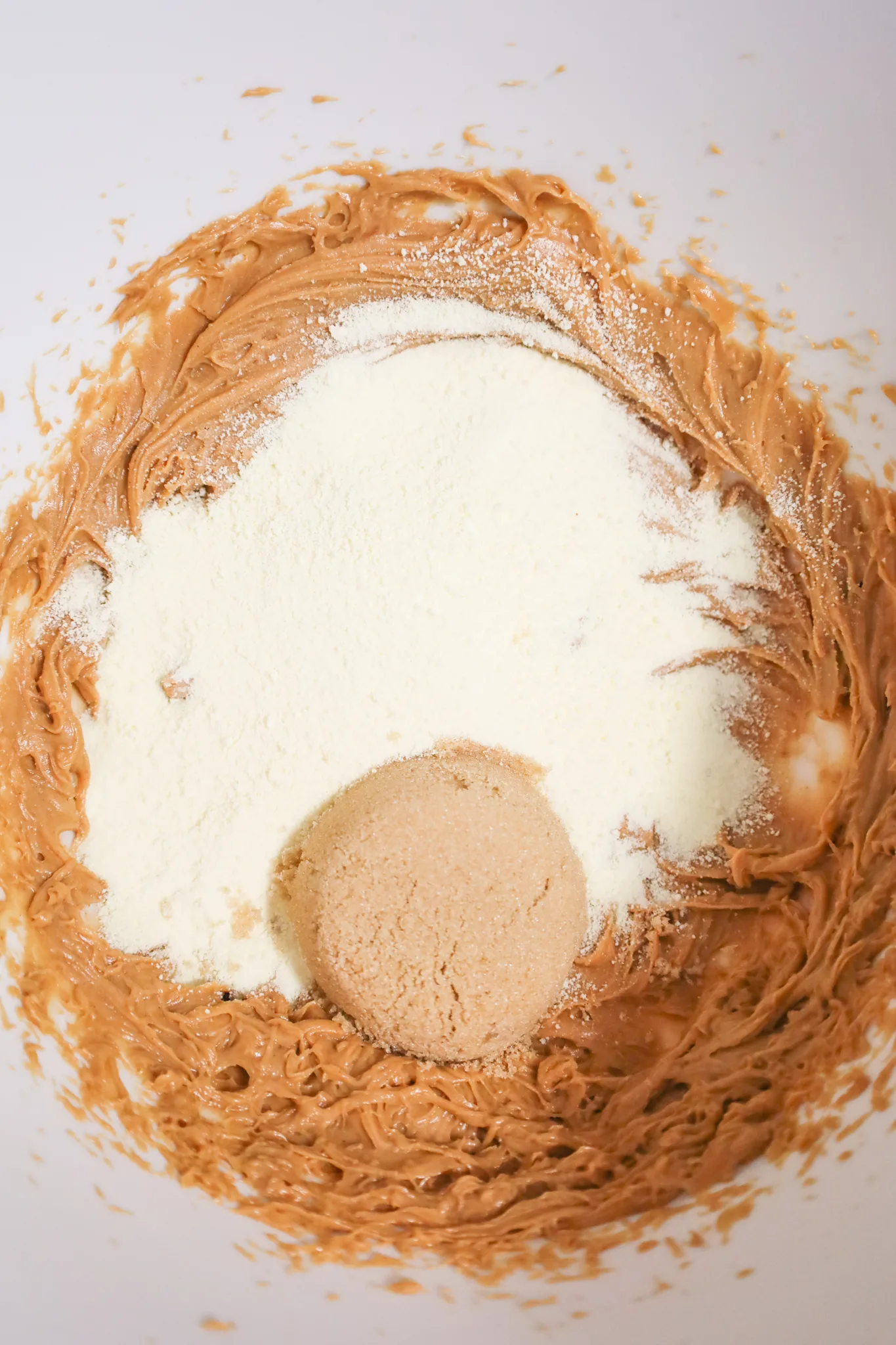 powdered milk, brown sugar and peanut butter mixture in mixing bowl