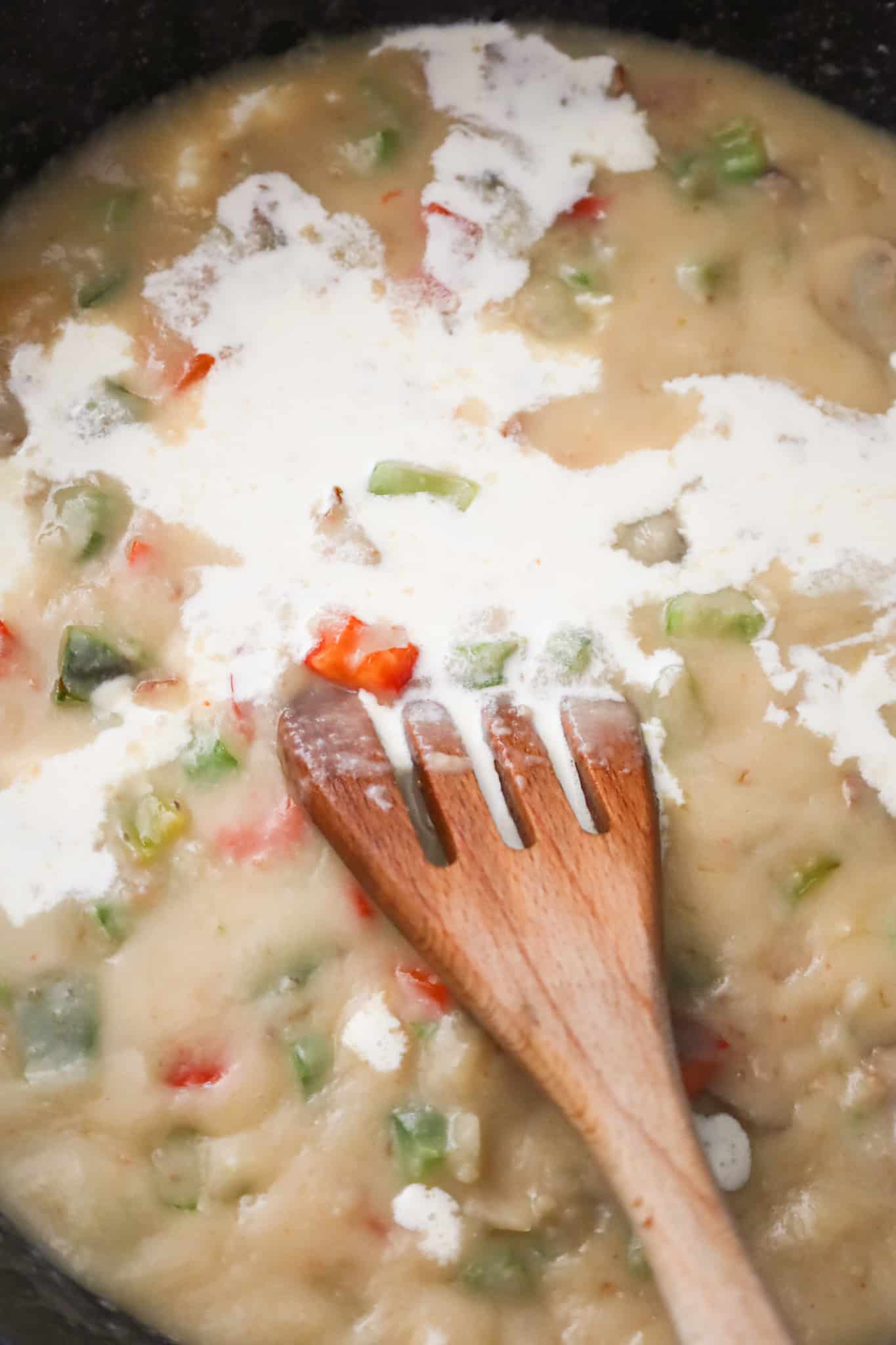 heavy cream added to thick broth mixture in a skillet