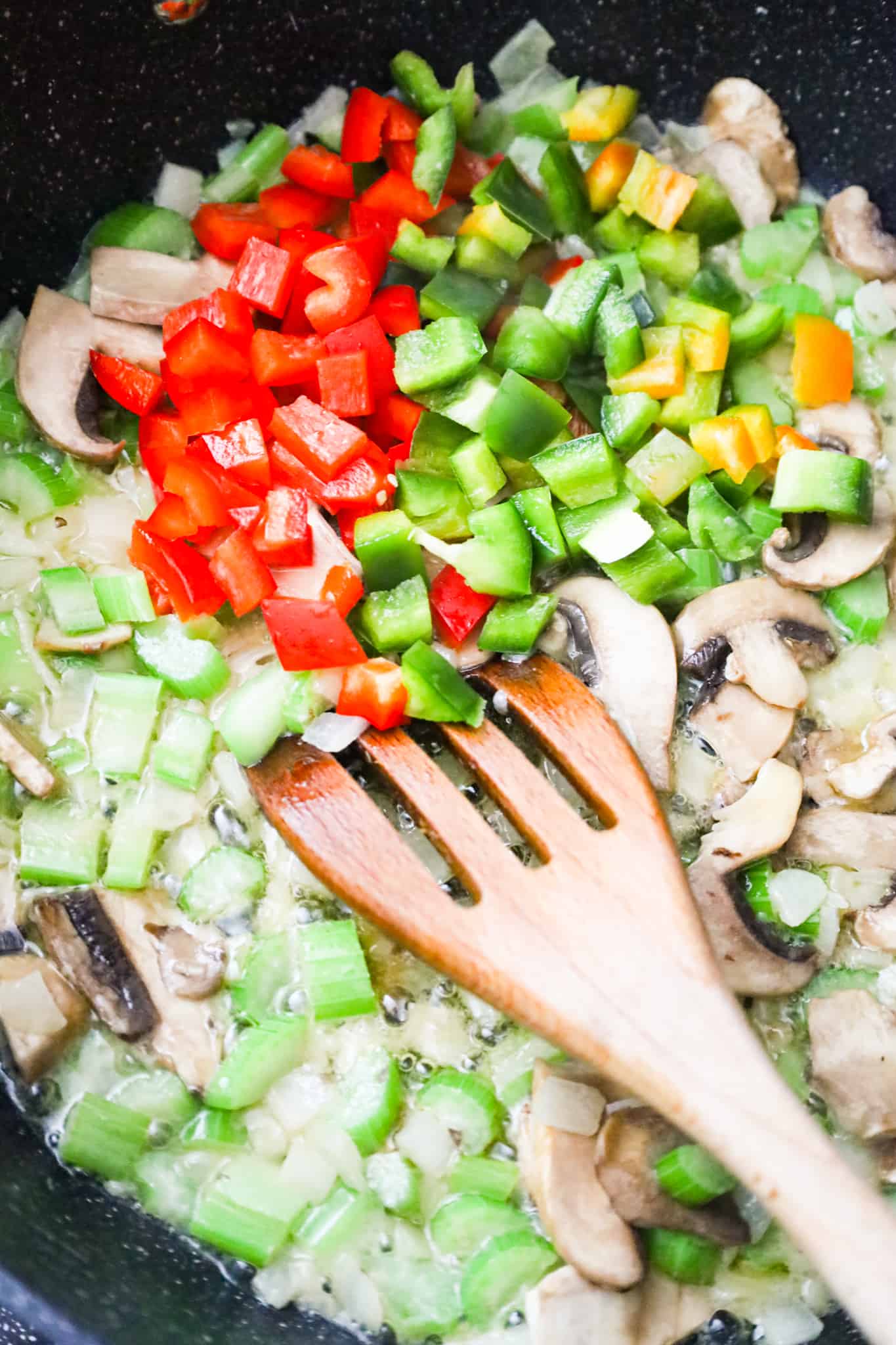diced bell peppers, diced celery and sliced mushrooms in a skillet