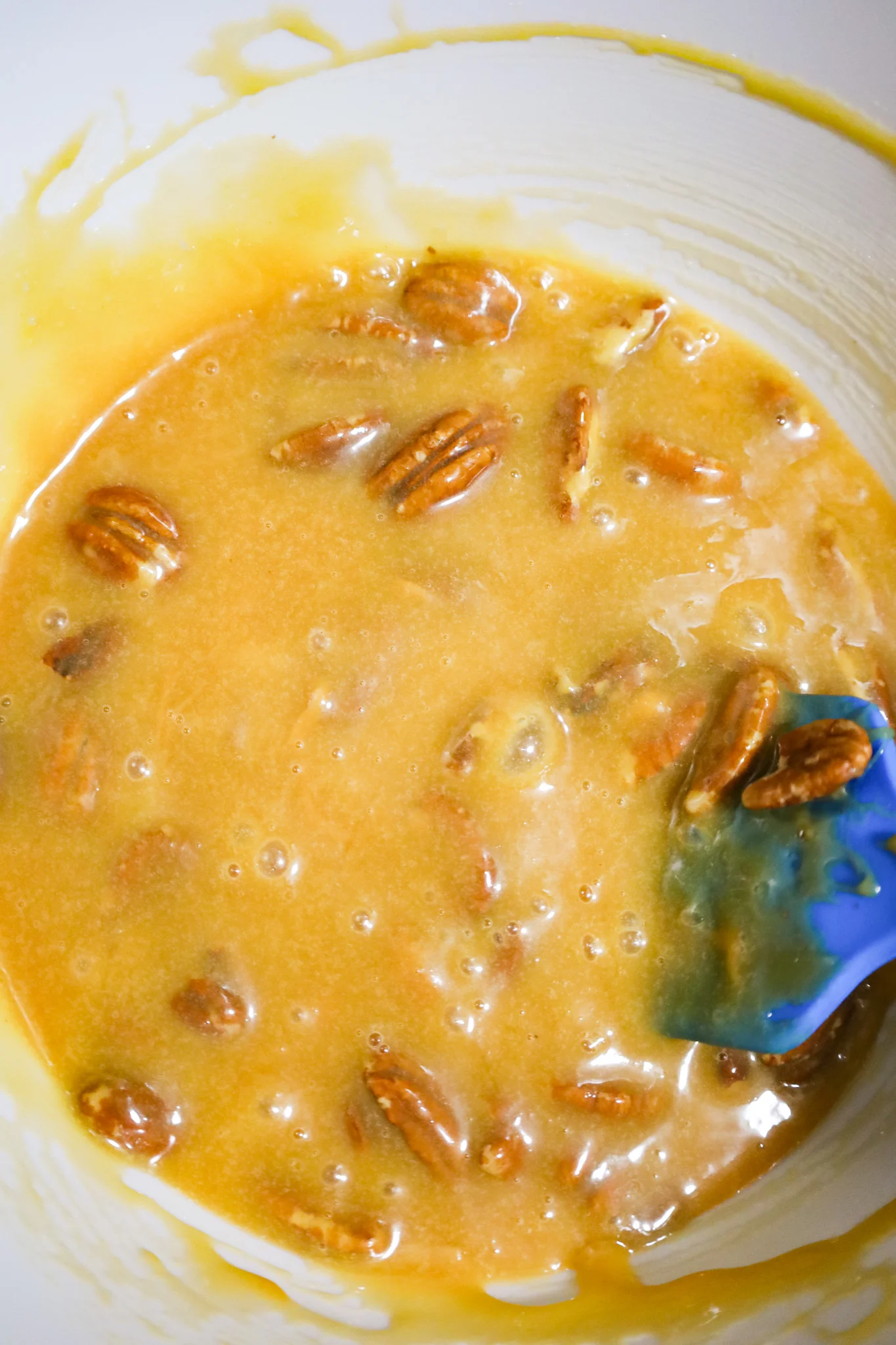 caramel pecan pie filling mixture in a mixing bowl