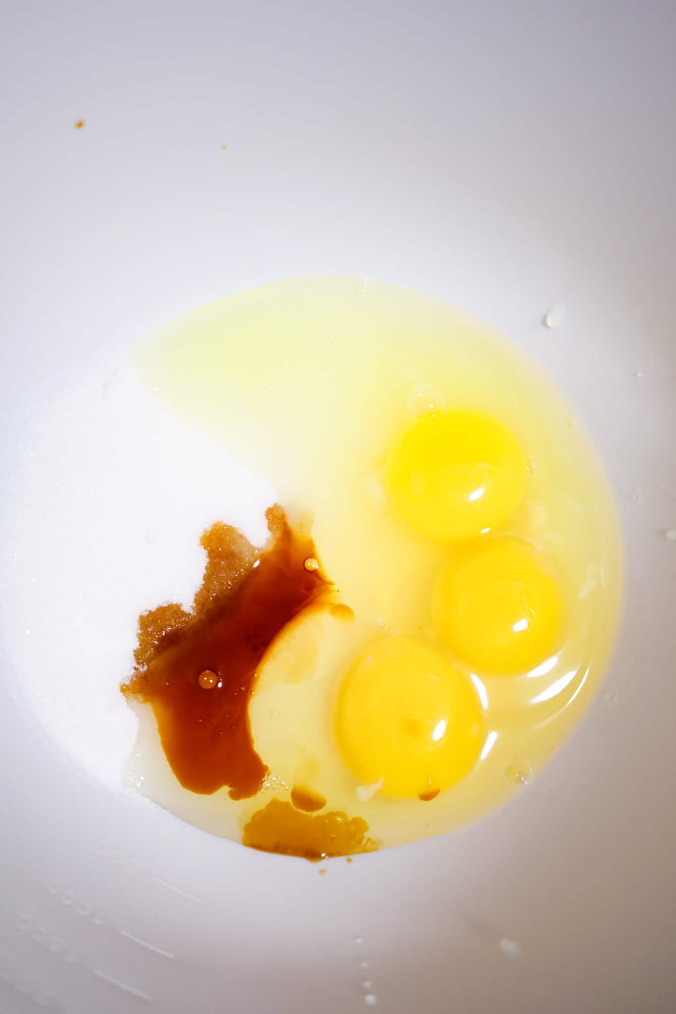 eggs, vanilla extract and granulated sugar in a mixing bowl