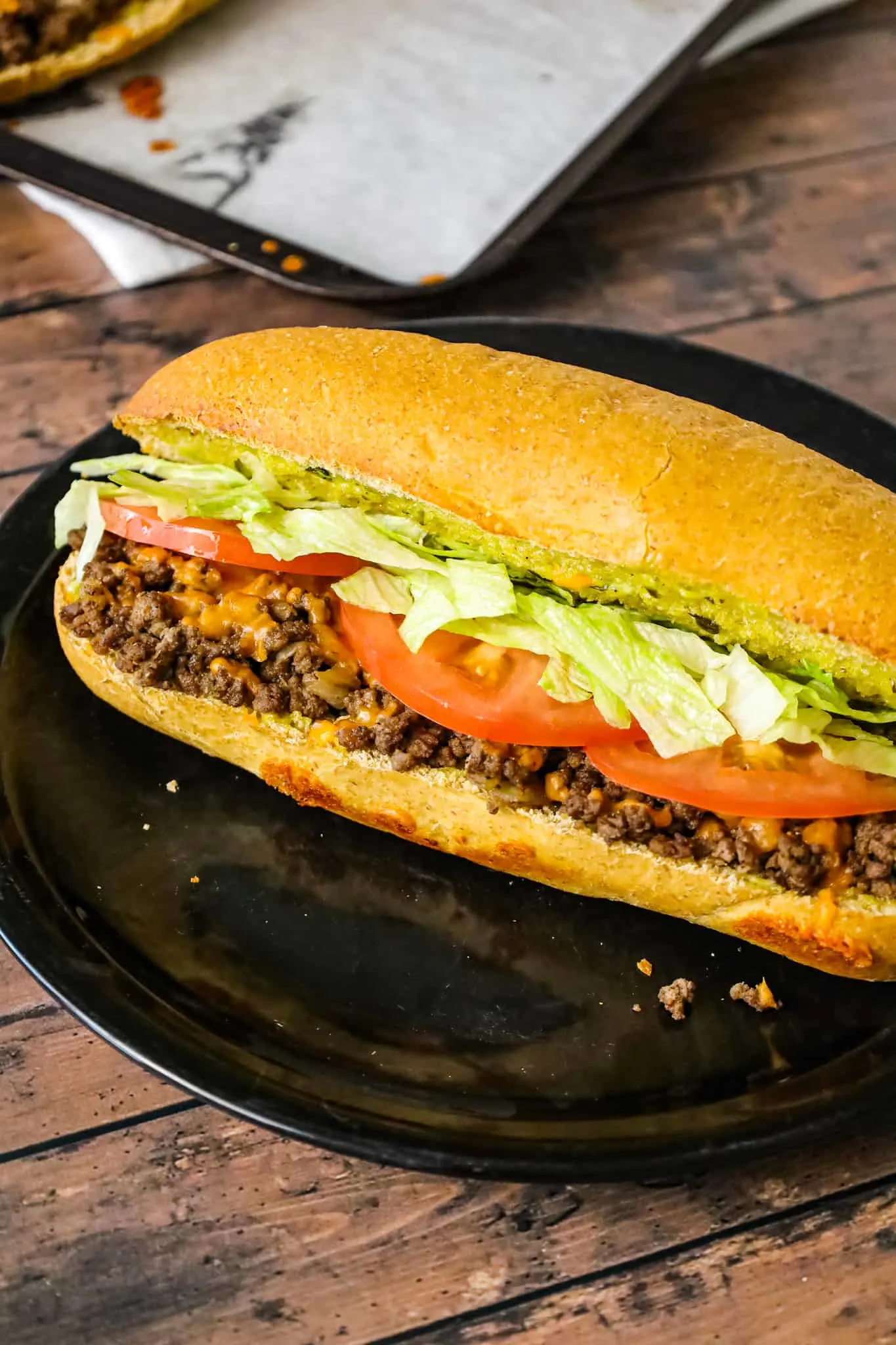 Cheeseburger Subs are an easy family friendly dinner recipe loaded with ground beef, shredded cheddar cheese on a bun spread with a special mayo sauce.