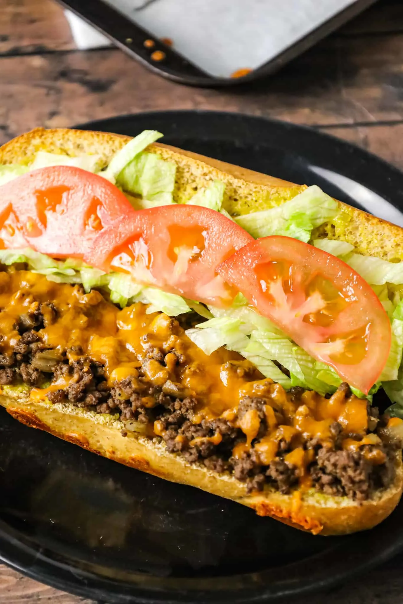 Cheeseburger Subs are an easy family friendly dinner recipe loaded with ground beef, shredded cheddar cheese on a bun spread with a special mayo sauce.