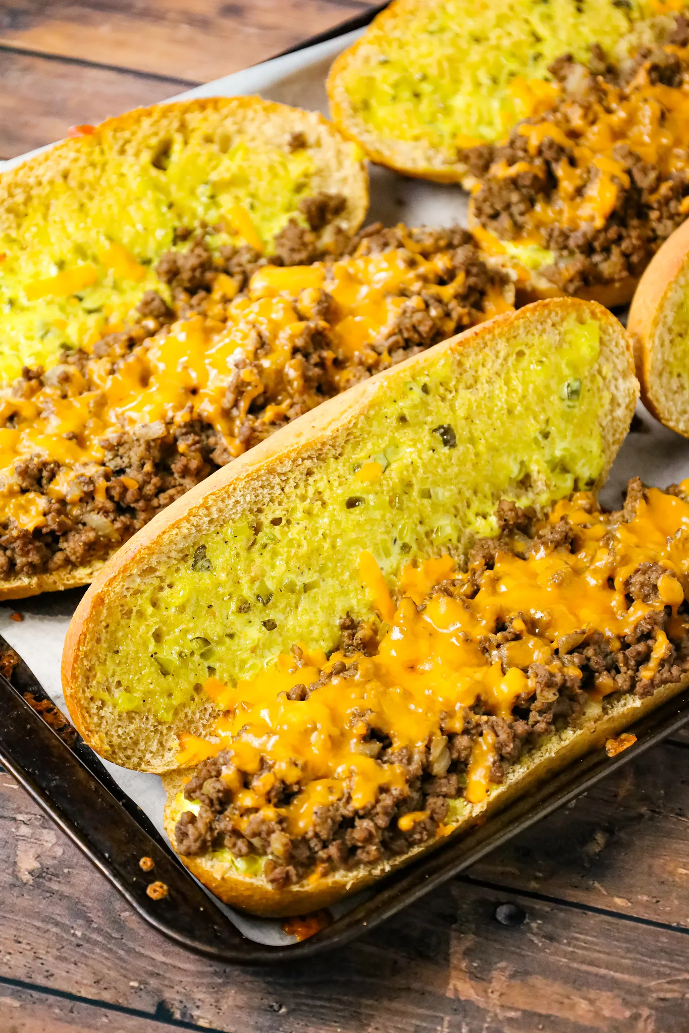 Cheeseburger Subs are an easy family friendly dinner recipe loaded with ground beef, shredded cheddar cheese on a bun spread with a special mayo sauce.