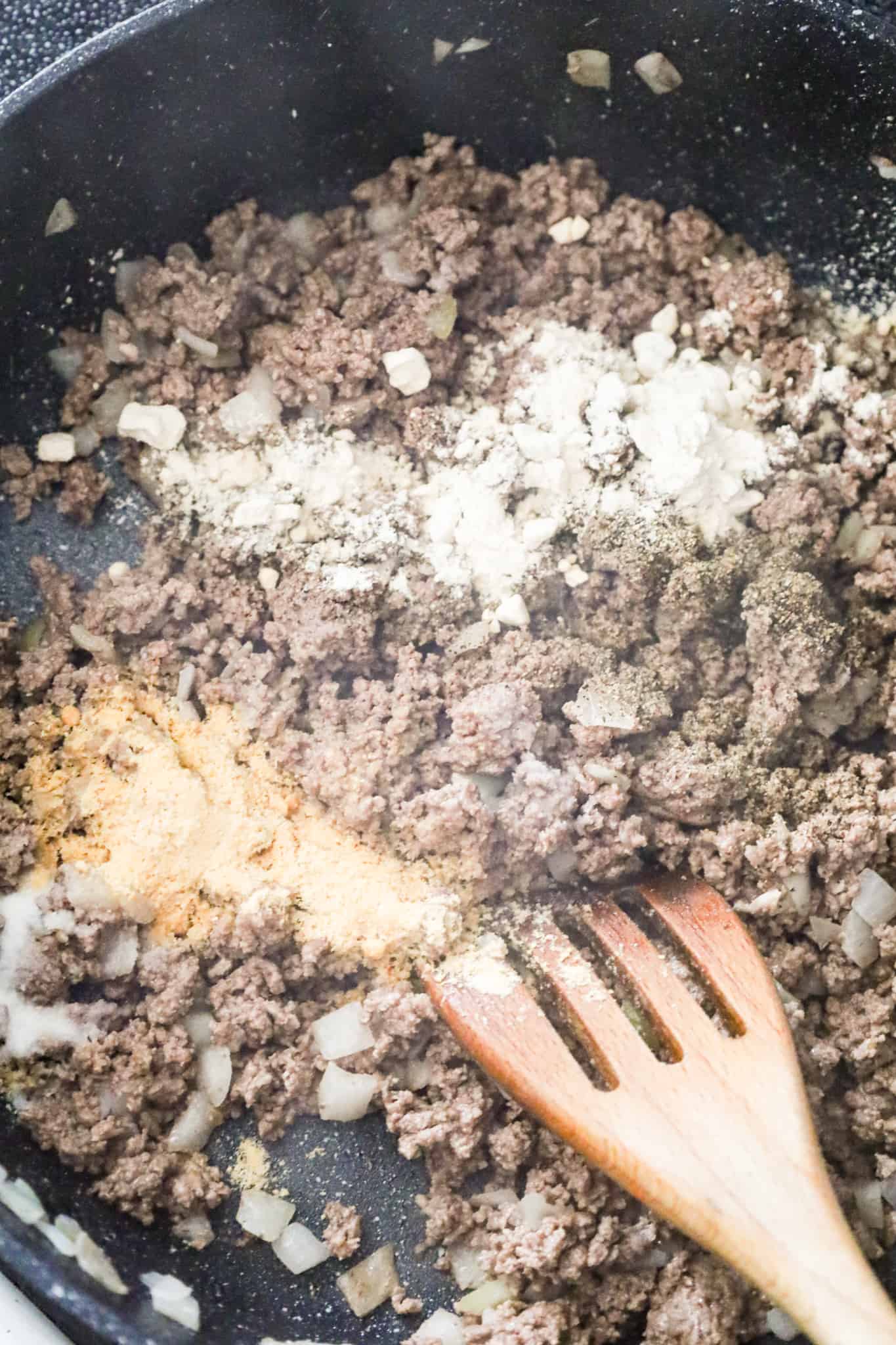 spices on top of cooked ground beef in a skillet