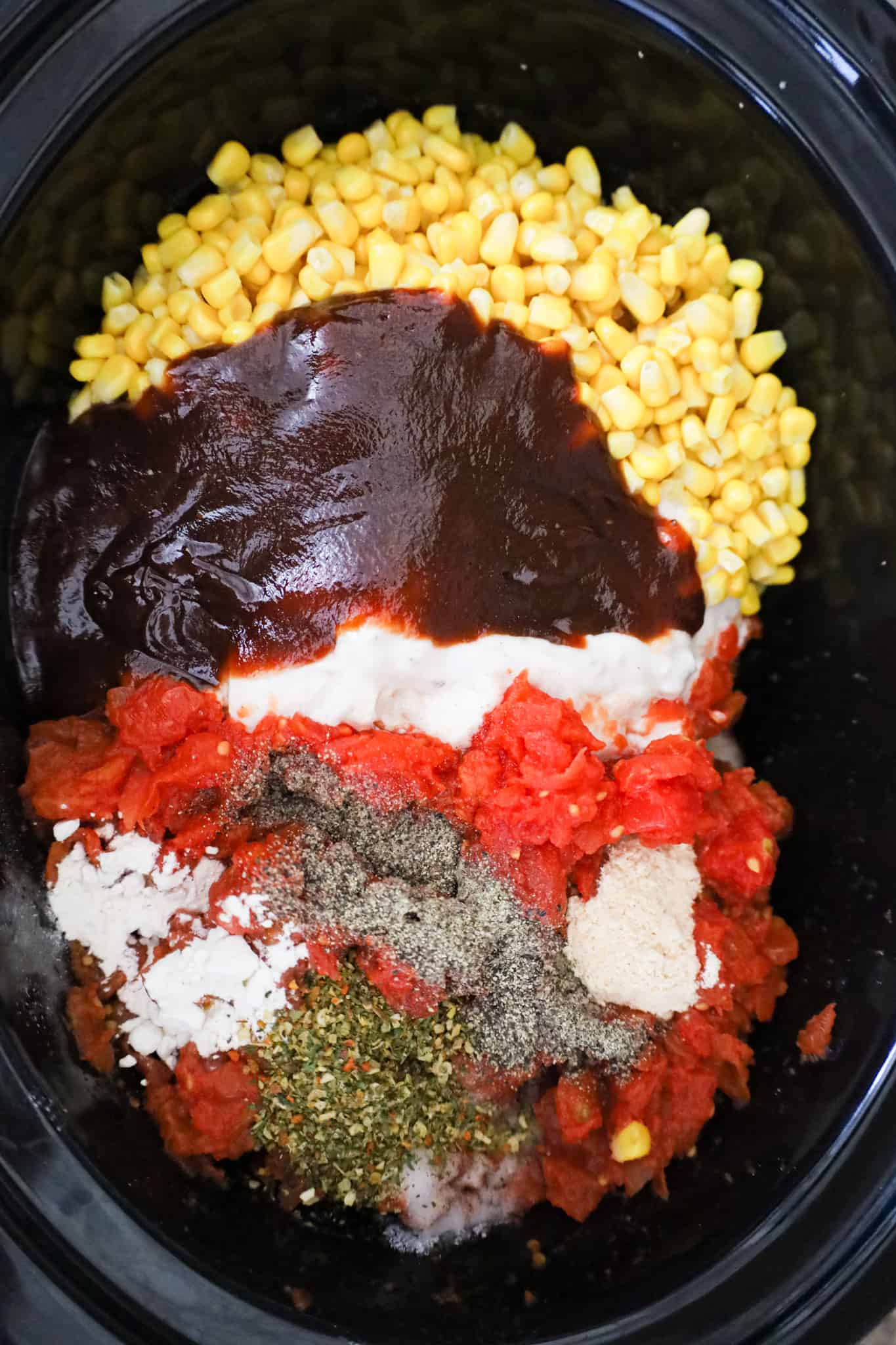 bbq sauce, diced tomatoes, corn and spices in a crock pot