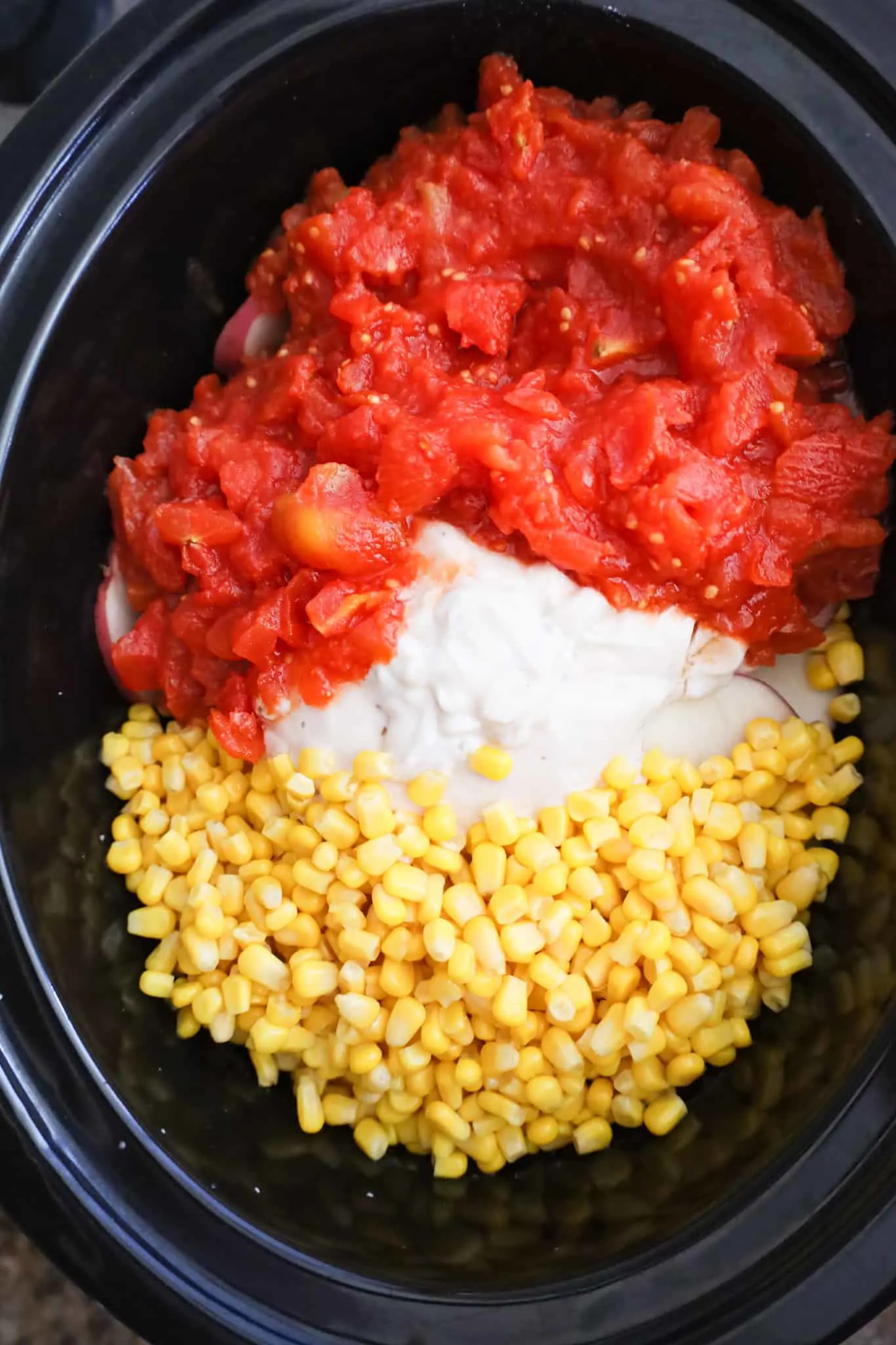 diced tomatoes, cream of mushroom soup and canned corn in a crock pot