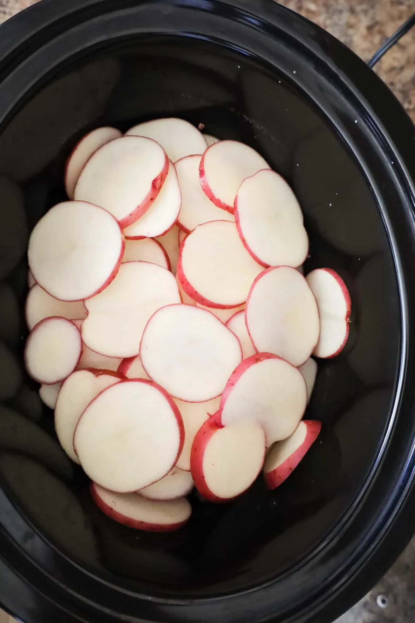 sliced red potatoes in a crock pot