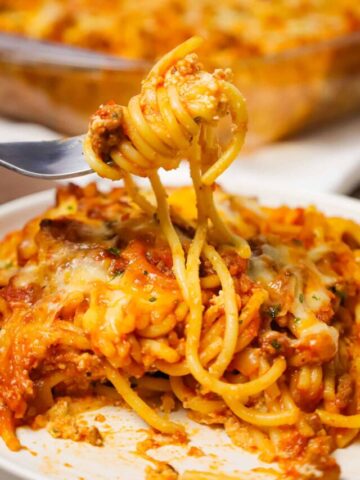 Southern Baked Spaghetti is a hearty baked pasta recipe loaded with ground beef, marinara, ricotta, parmesan, cheddar and mozzarella cheese.