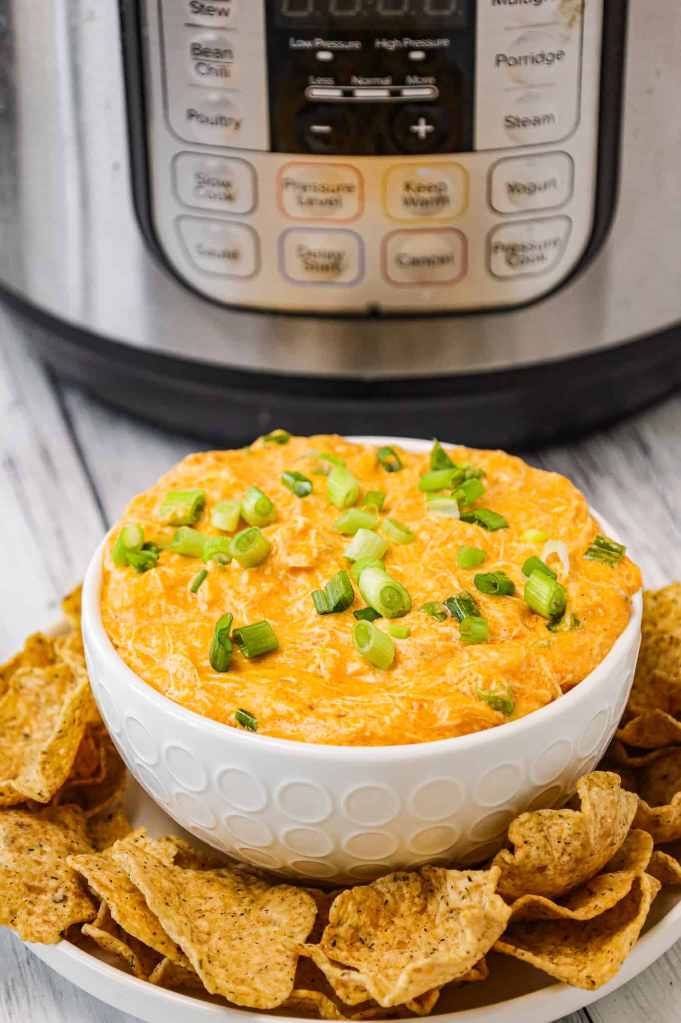 Instant Pot Buffalo Chicken Dip is a delicious pressure cooker party dip recipe loaded with shredded chicken, Buffalo sauce, ranch dressing, cream cheese and a blend of shredded cheeses.