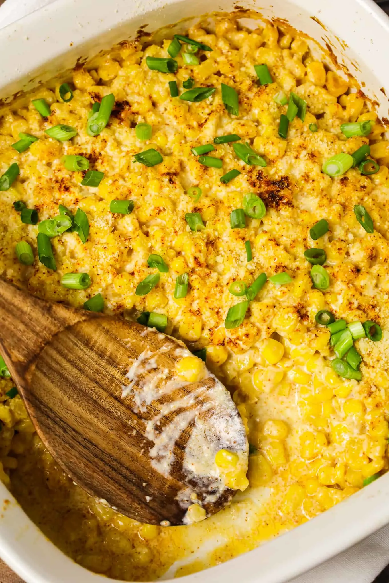 Mexican Corn Casserole is a creamy corn casserole made with frozen corn kernels tossed in sour cream, mayo, chili powder, garlic powder and parmesan cheese.