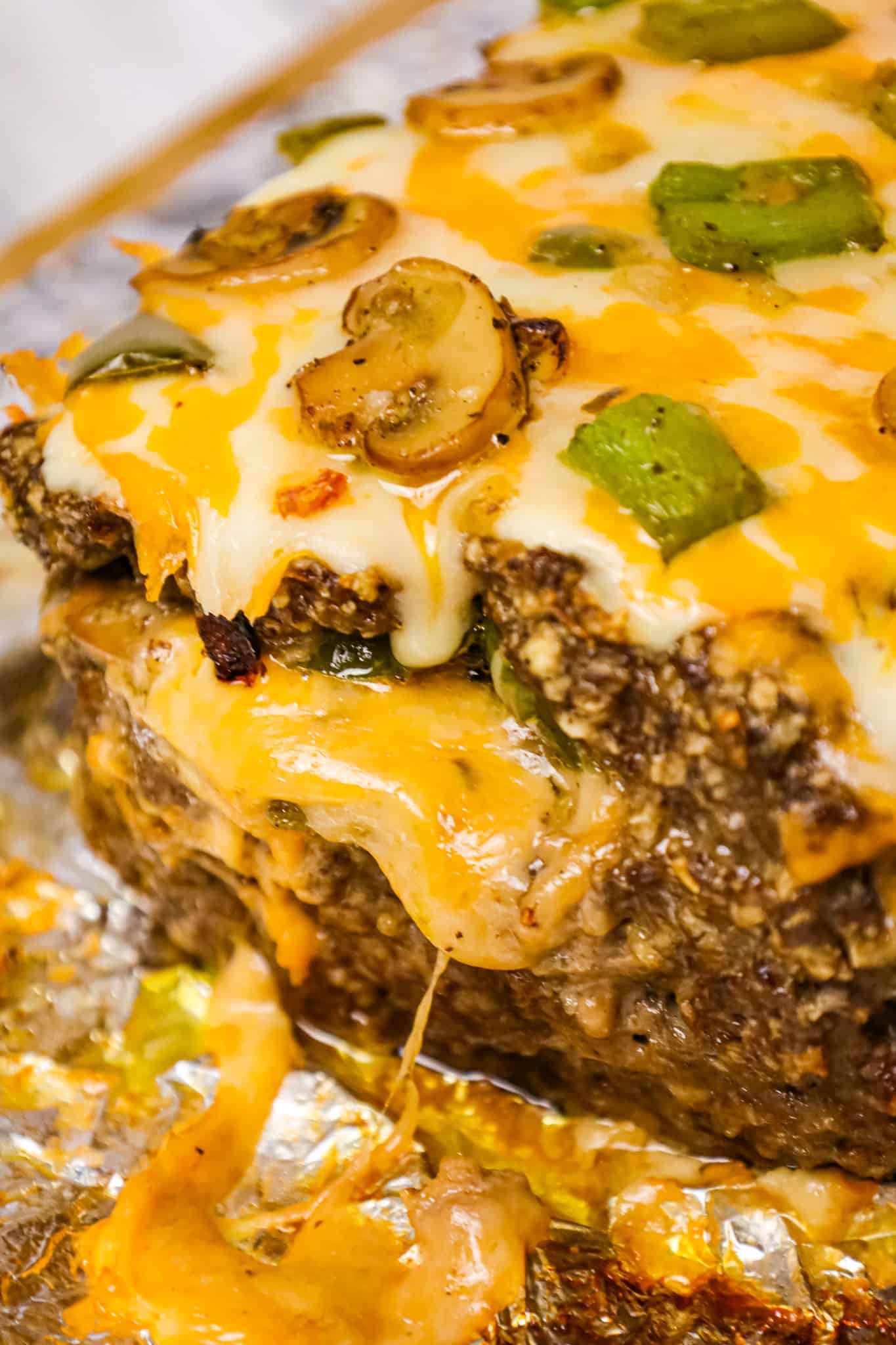 Philly Cheese Steak Meatloaf is a hearty ground beef meatloaf loaded with onions, green peppers, mushrooms and cheese.