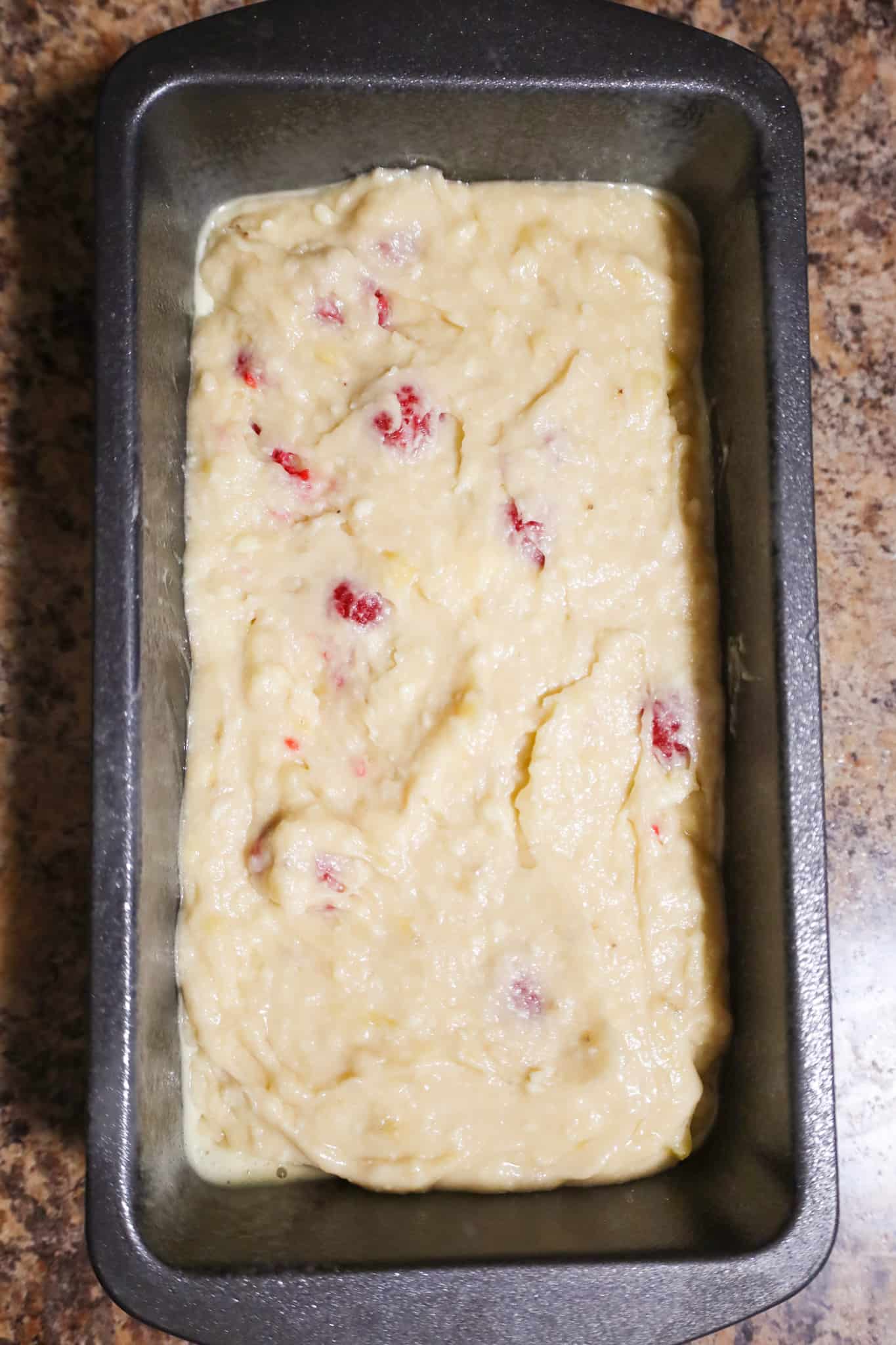 raspberry banana bread batter in a mixing bowl