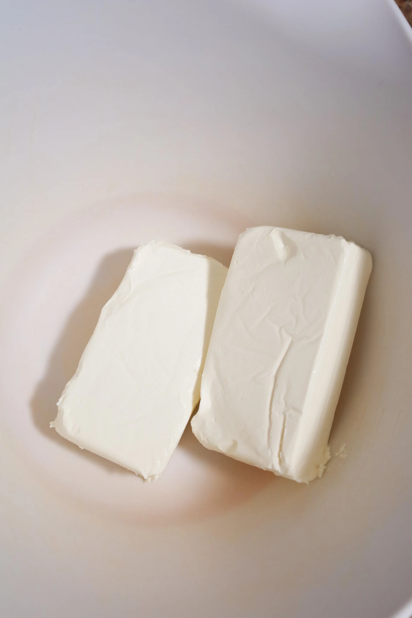 cream cheese bricks in a mixing bowl