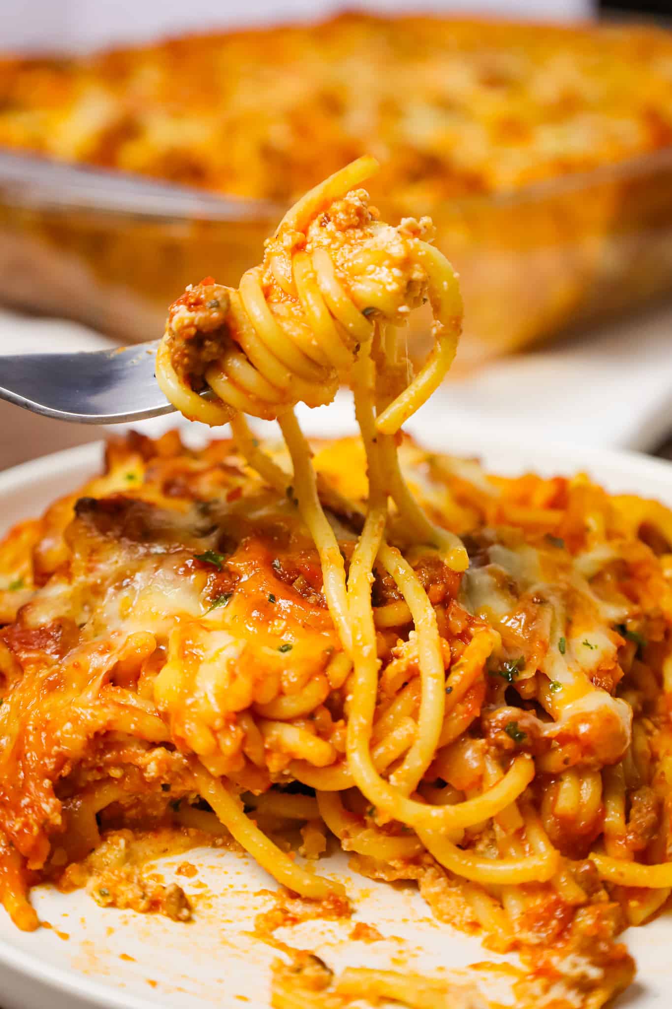 Southern Baked Spaghetti is a hearty baked pasta recipe loaded with ground beef, marinara, ricotta, parmesan, cheddar and mozzarella cheese.