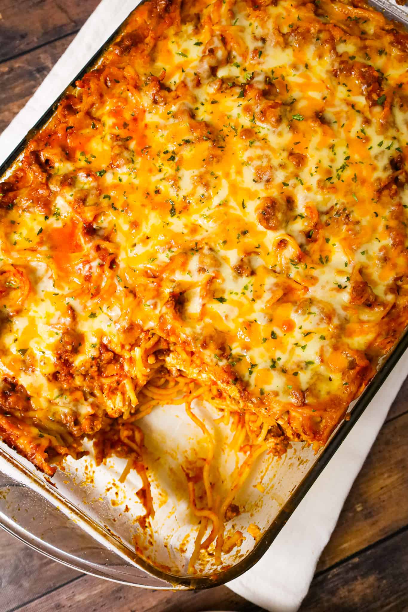 Southern Baked Spaghetti is a hearty baked pasta recipe loaded with ground beef, marinara, ricotta, parmesan, cheddar and mozzarella cheese.