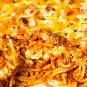 Southern Baked Spaghetti is a hearty baked pasta recipe loaded with ground beef, marinara, ricotta, parmesan, cheddar and mozzarella cheese.