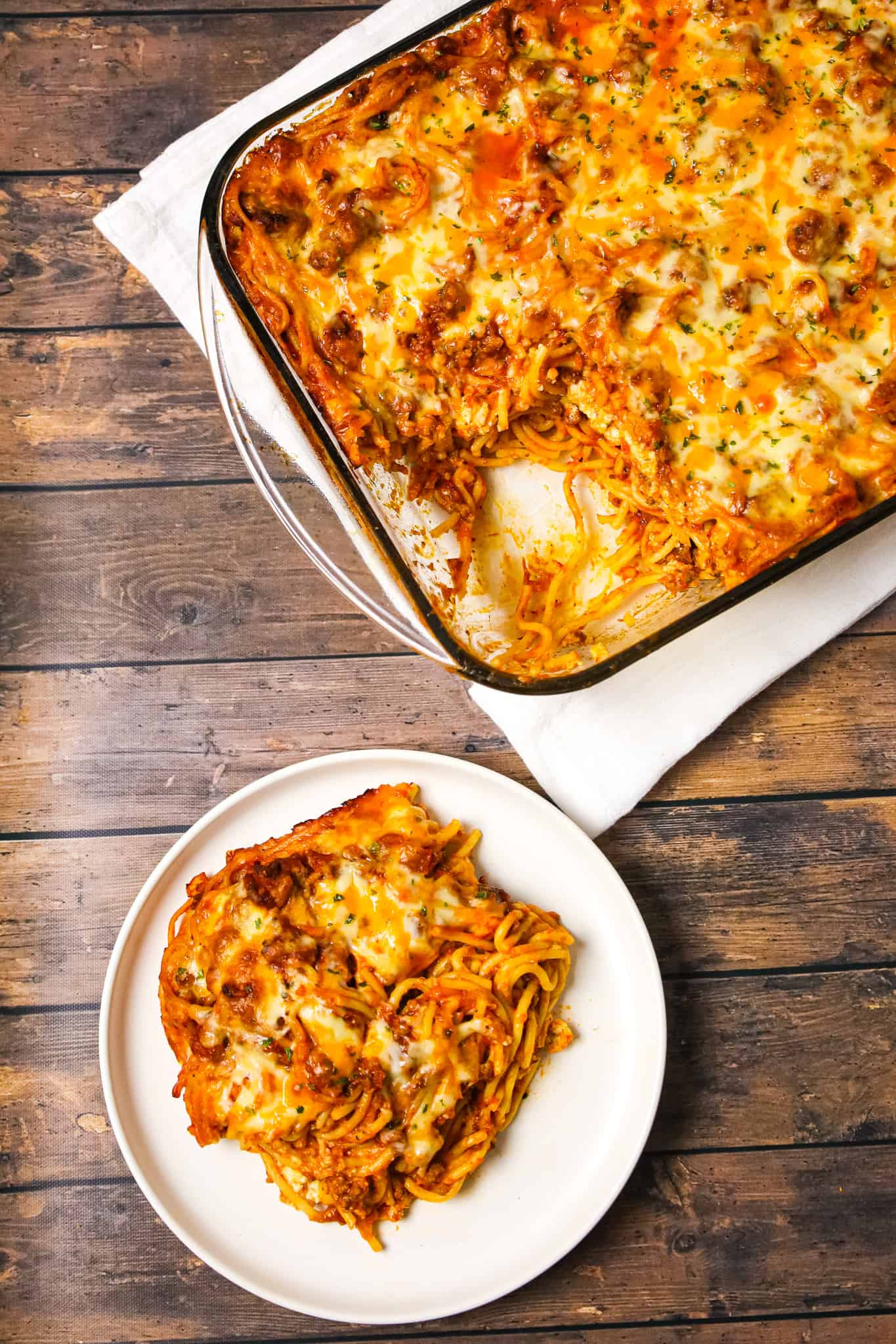 Southern Baked Spaghetti is a hearty baked pasta recipe loaded with ground beef, marinara, ricotta, parmesan, cheddar and mozzarella cheese.