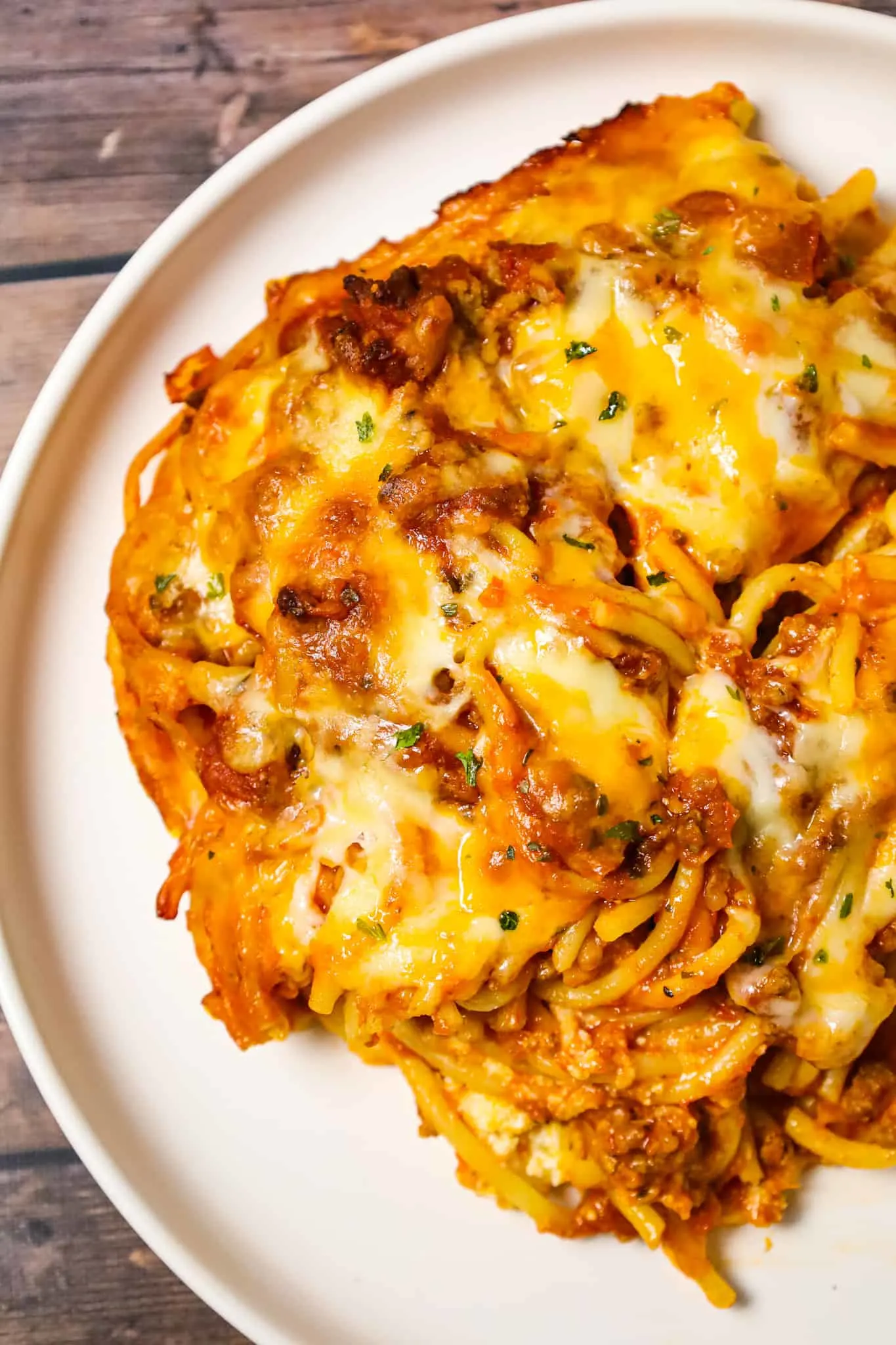 Southern Baked Spaghetti is a hearty baked pasta recipe loaded with ground beef, marinara, ricotta, parmesan, cheddar and mozzarella cheese.