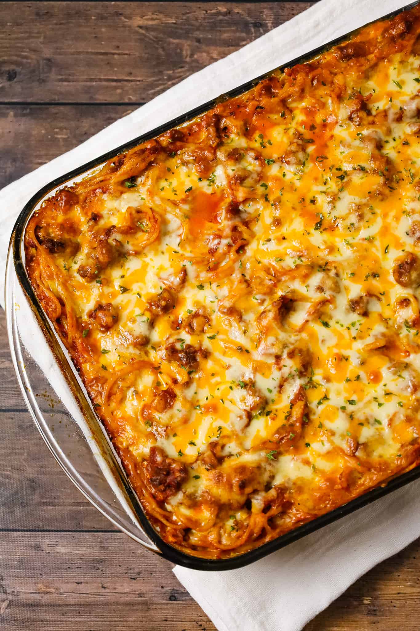 Southern Baked Spaghetti is a hearty baked pasta recipe loaded with ground beef, marinara, ricotta, parmesan, cheddar and mozzarella cheese.