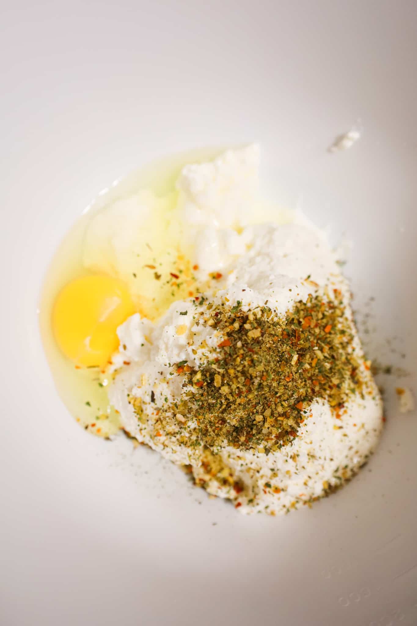 ricotta cheese, and egg and Italian seasoning in a mixing bowl