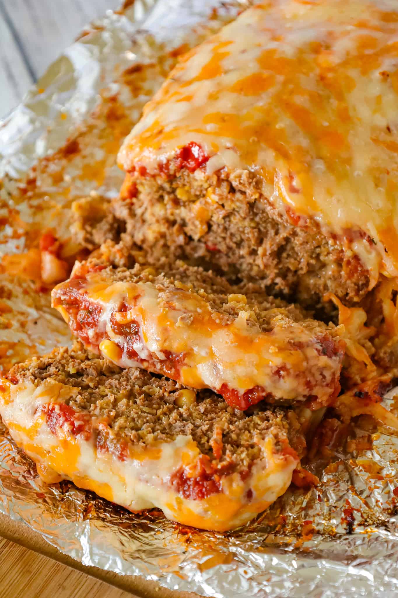 Taco Meatloaf is a delicious ground beef meatloaf recipe loaded with crushed Fritos corn chips, salsa, taco seasoning and shredded cheese.