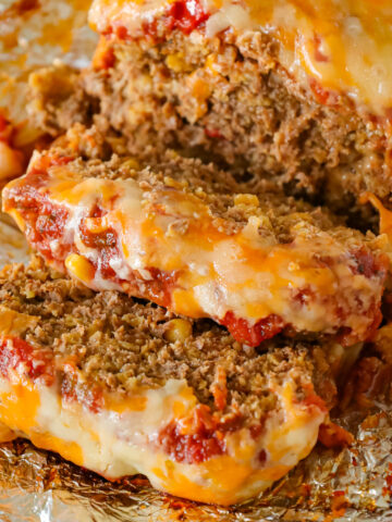 Taco Meatloaf is a delicious ground beef meatloaf recipe loaded with crushed Fritos corn chips, salsa, taco seasoning and shredded cheese.