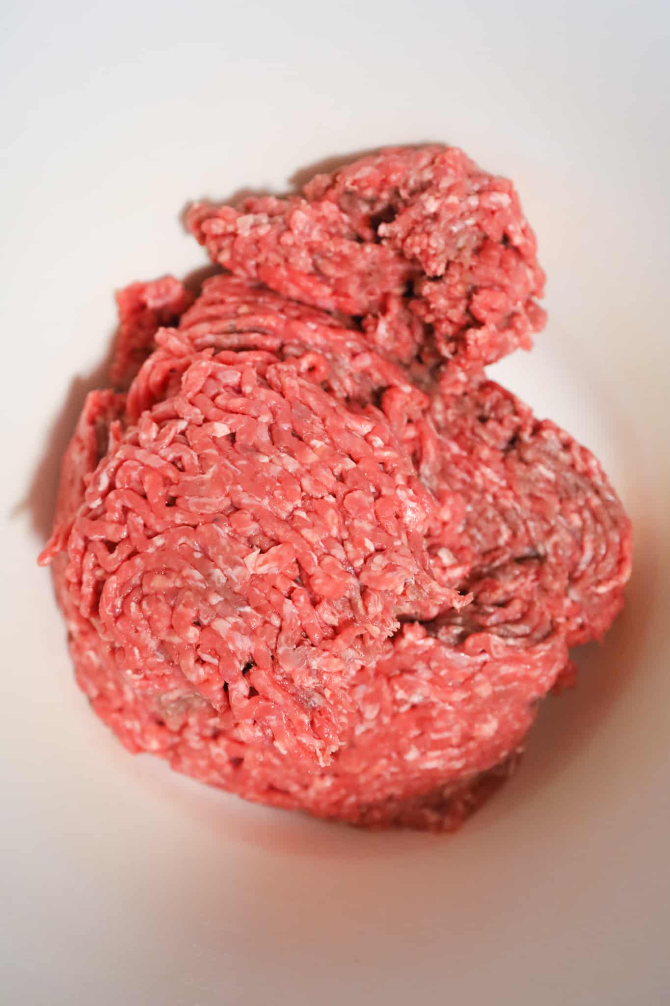 raw lean ground beef in a mixing bowl