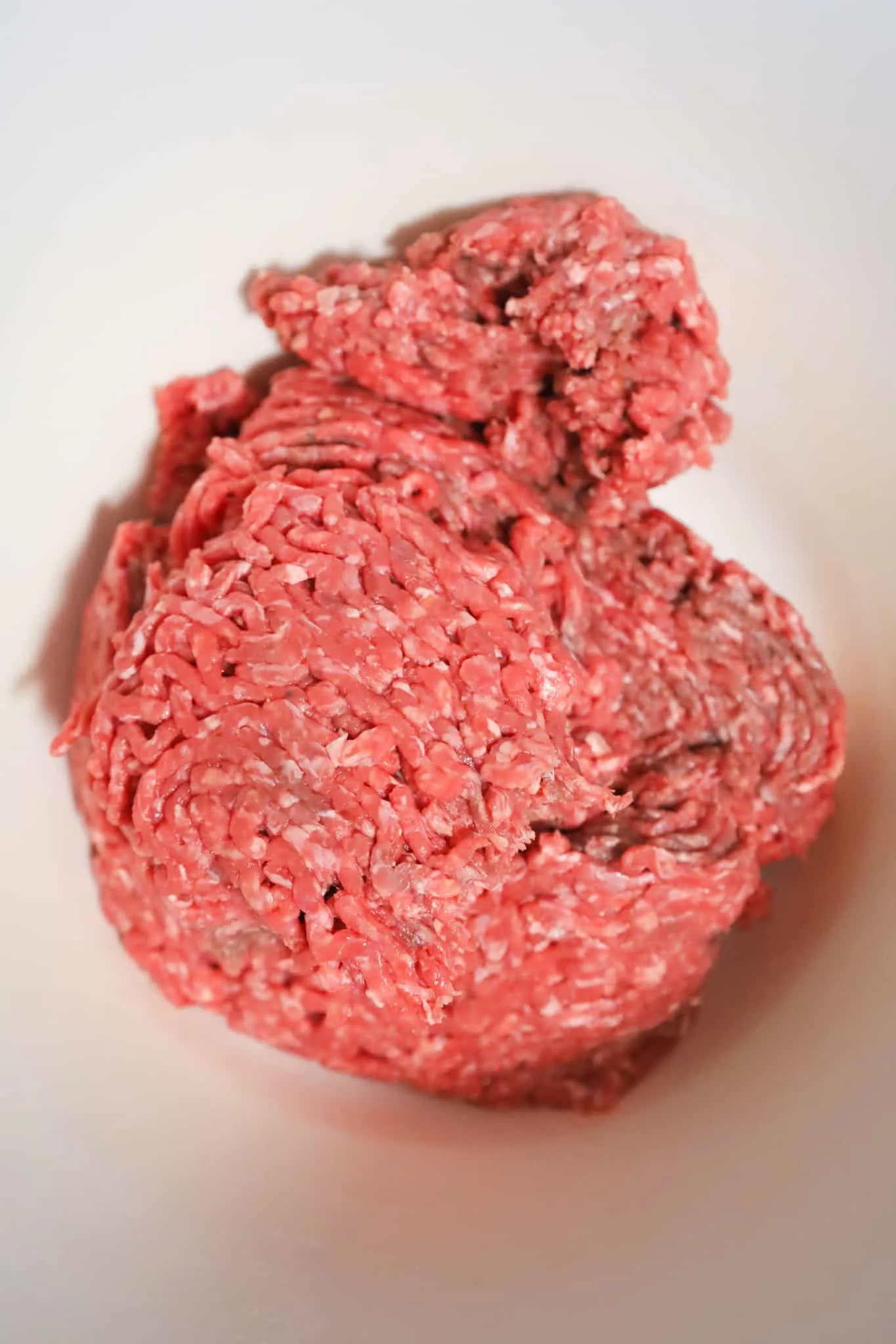 raw lean ground beef in a mixing bowl