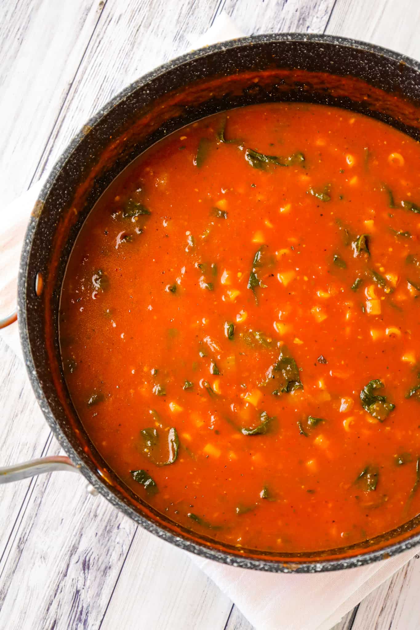 Tomato Florentine Soup is a hearty soup recipe made with crushed tomatoes and loaded with baby spinach and pasta.
