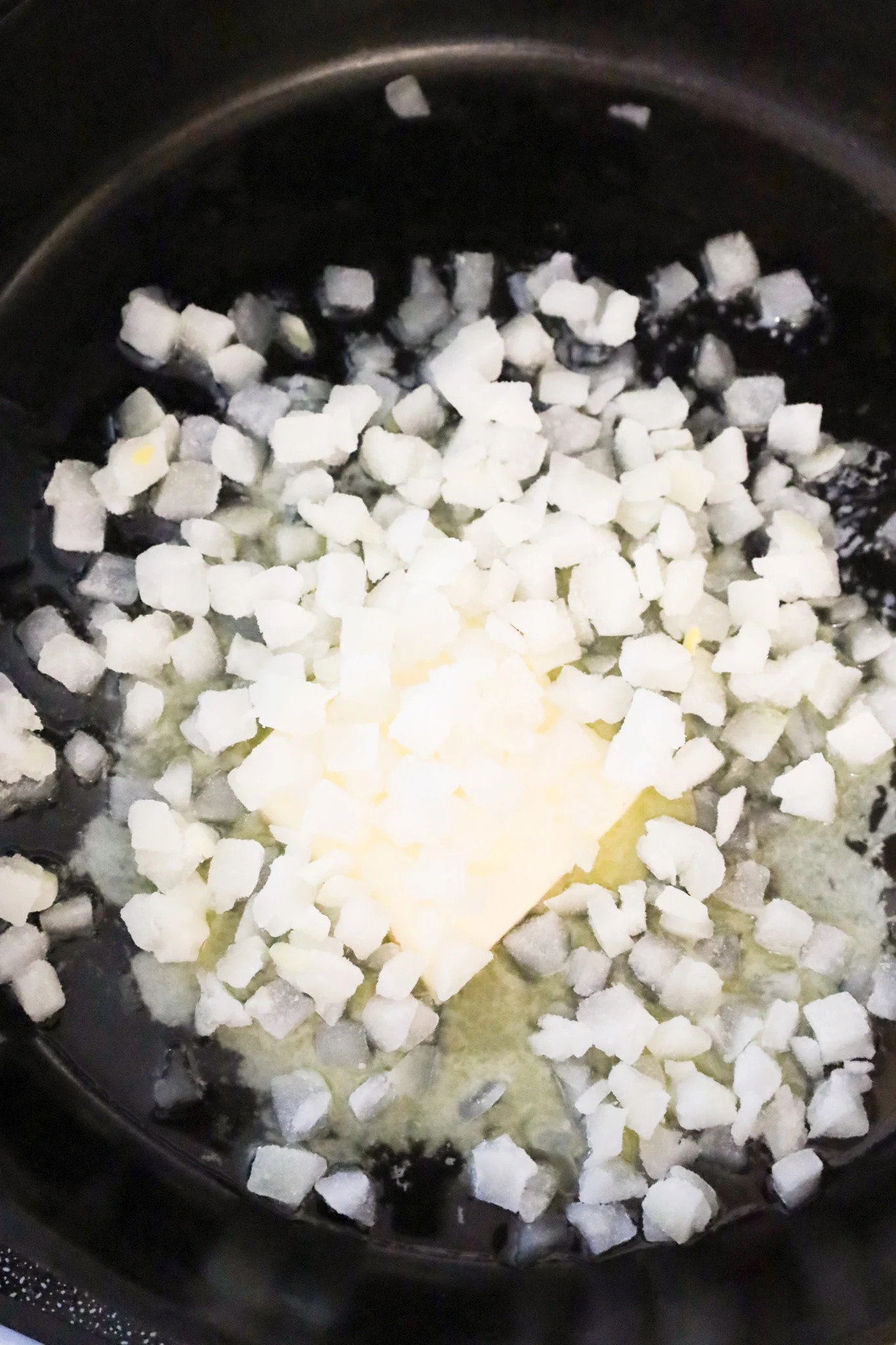 diced onions and butter in a cast iron skillet