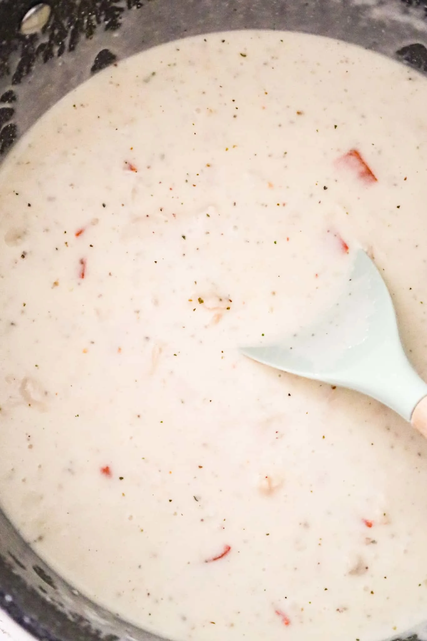 chicken and roasted red peppers stirred into creamy soup mixture