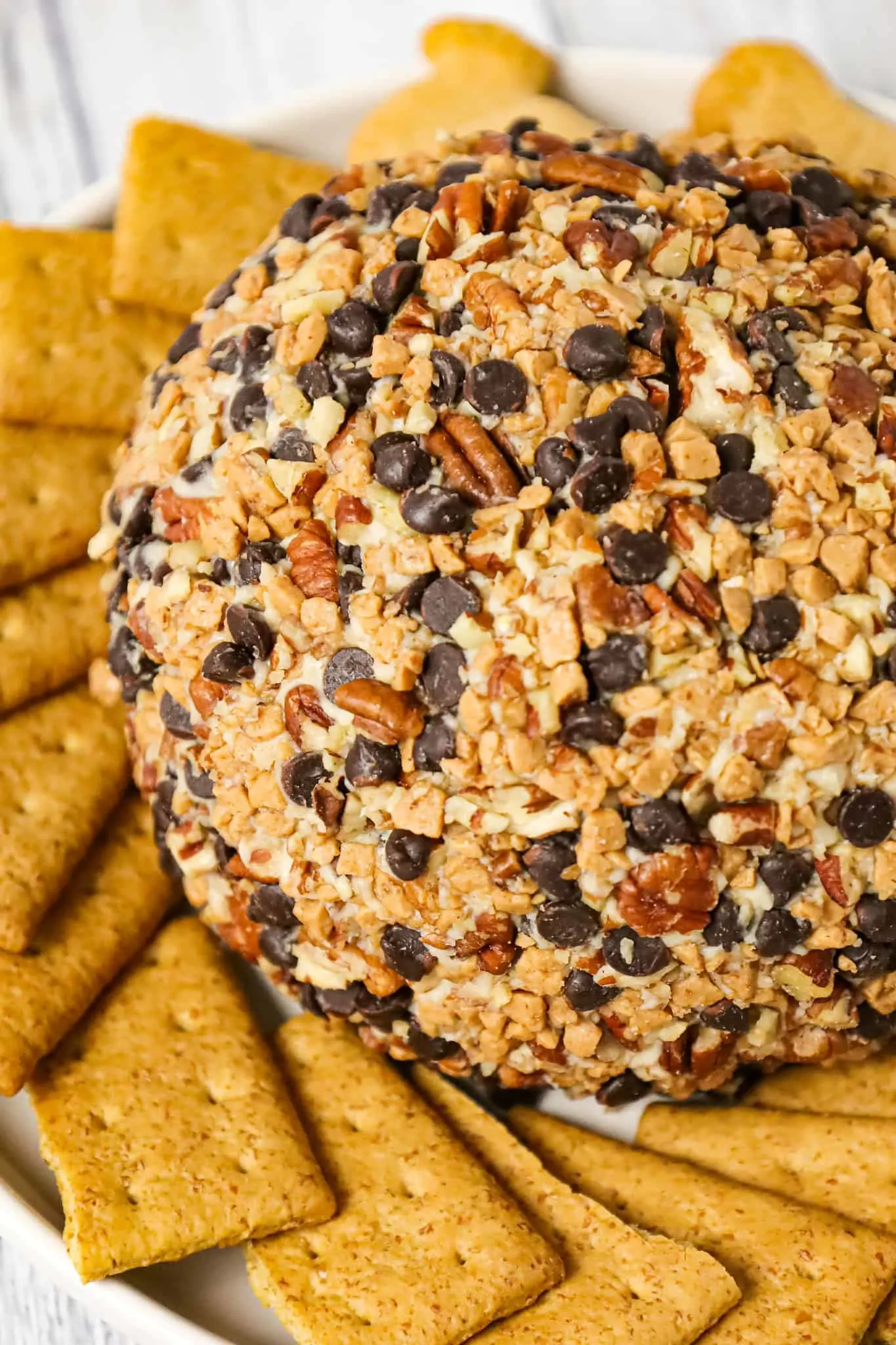 Chocolate Chip Cheese Ball is a tasty dessert dip recipe perfect for parties loaded with cream cheese, mini chocolate chips, toffee bits and chopped pecans.