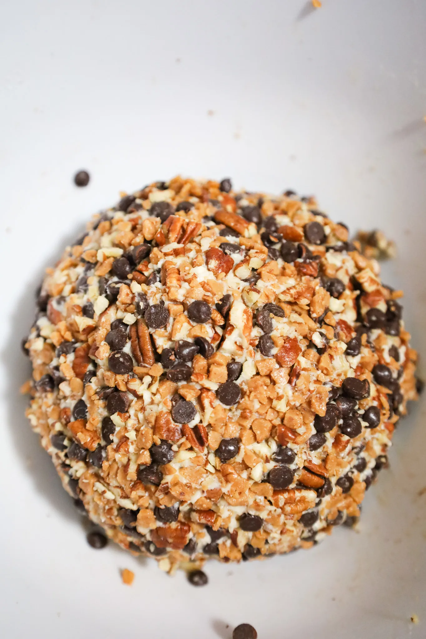 cream cheese ball coated in toffee bits, chocolate chips and chopped pecans