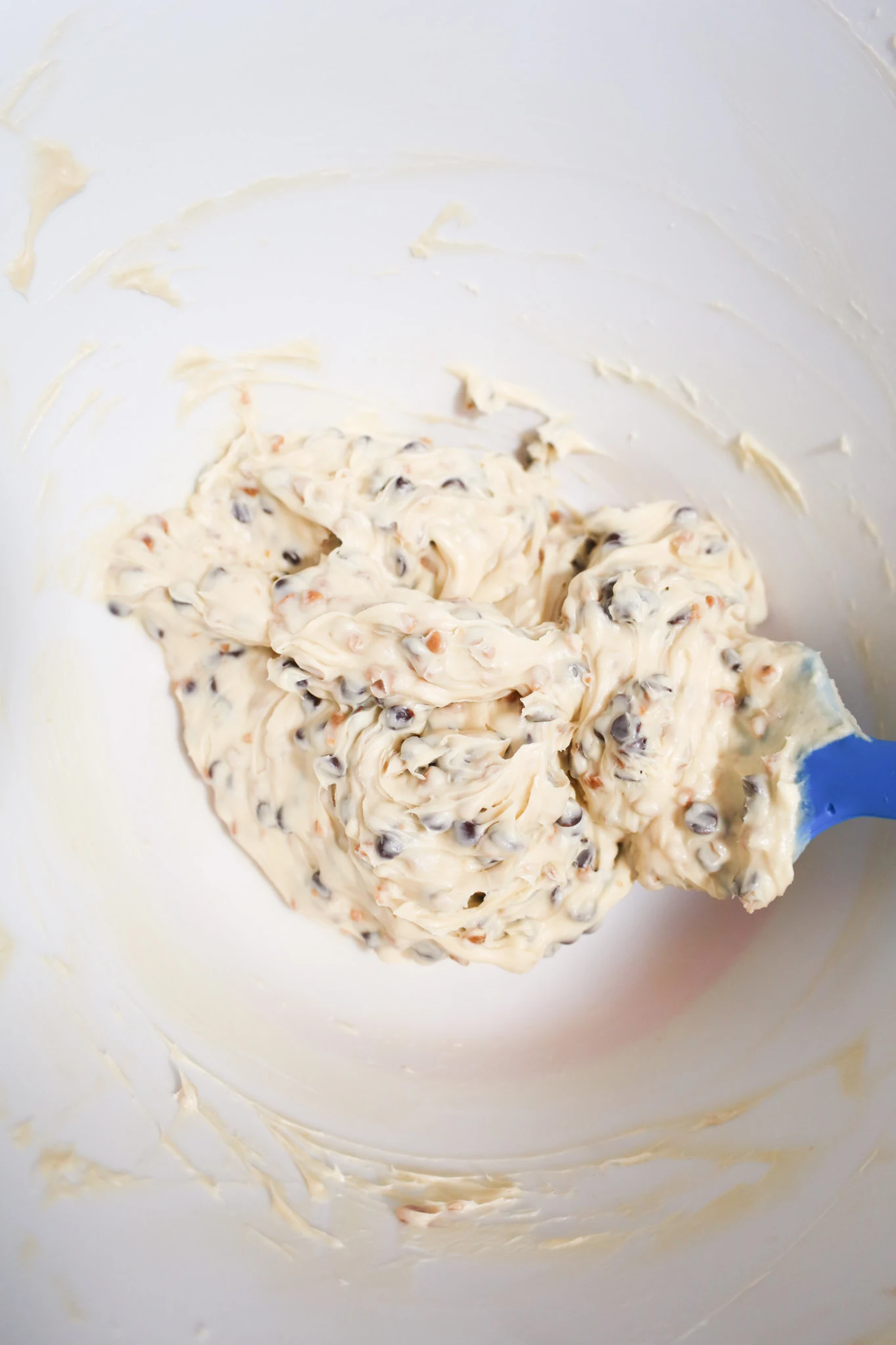 stirring chocolate chips and skor bits into cream cheese mixture