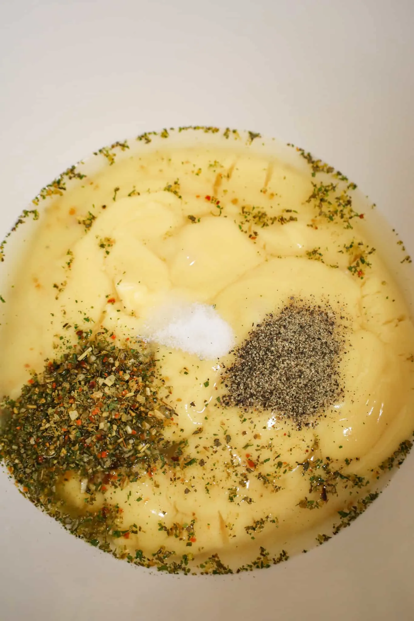 spices, water and condensed cream of chicken soup in a mixing bowl